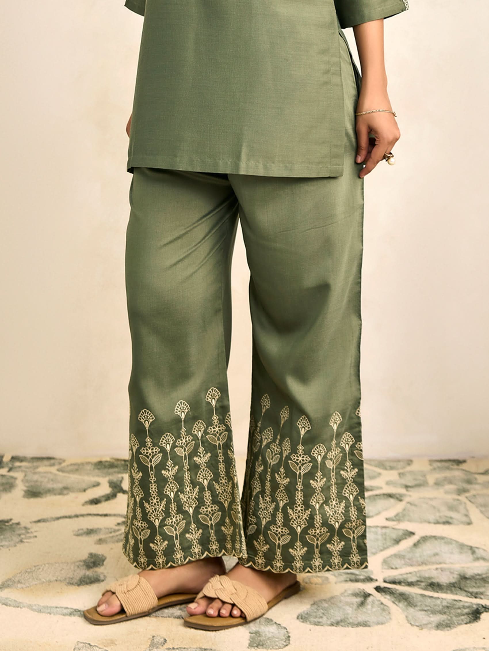 Green wide-leg trousers with embroidered hem and floral border