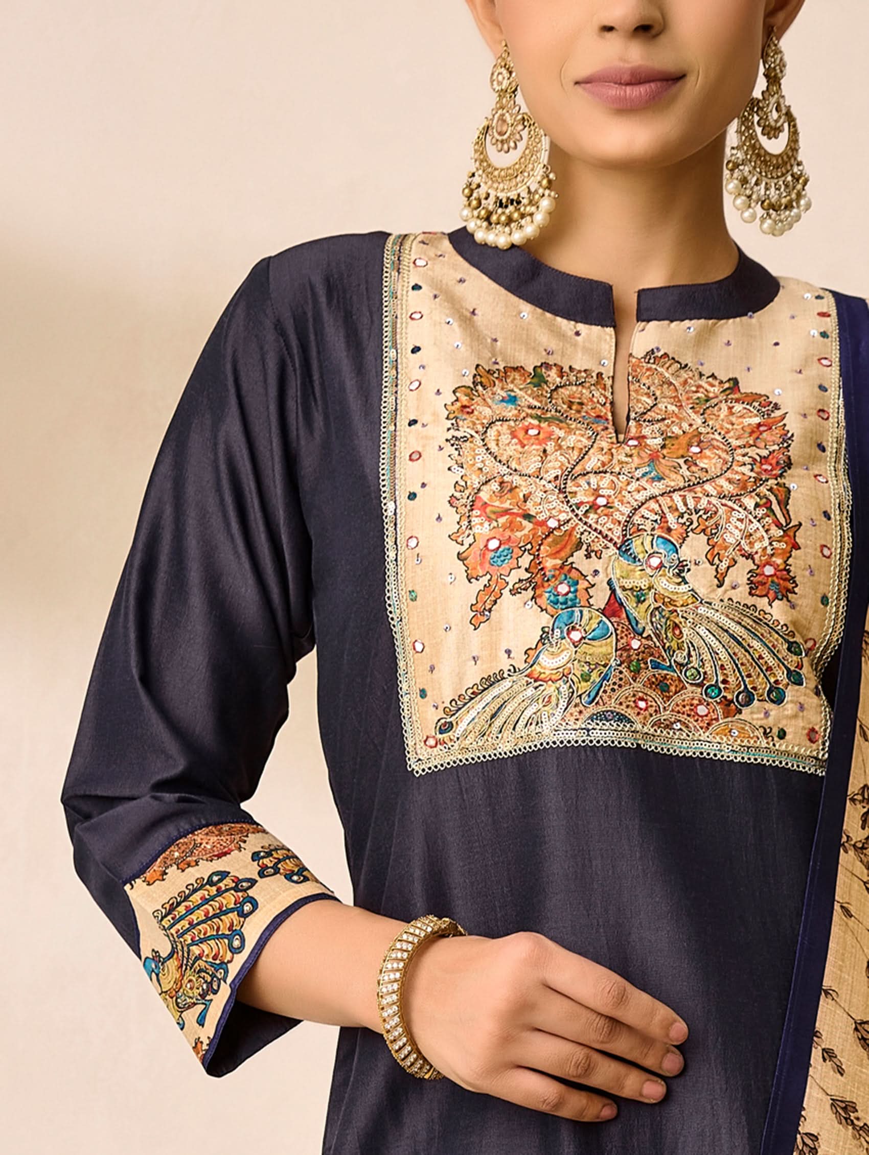 Navy blue kurta with intricate beige embroidery on a neutral background