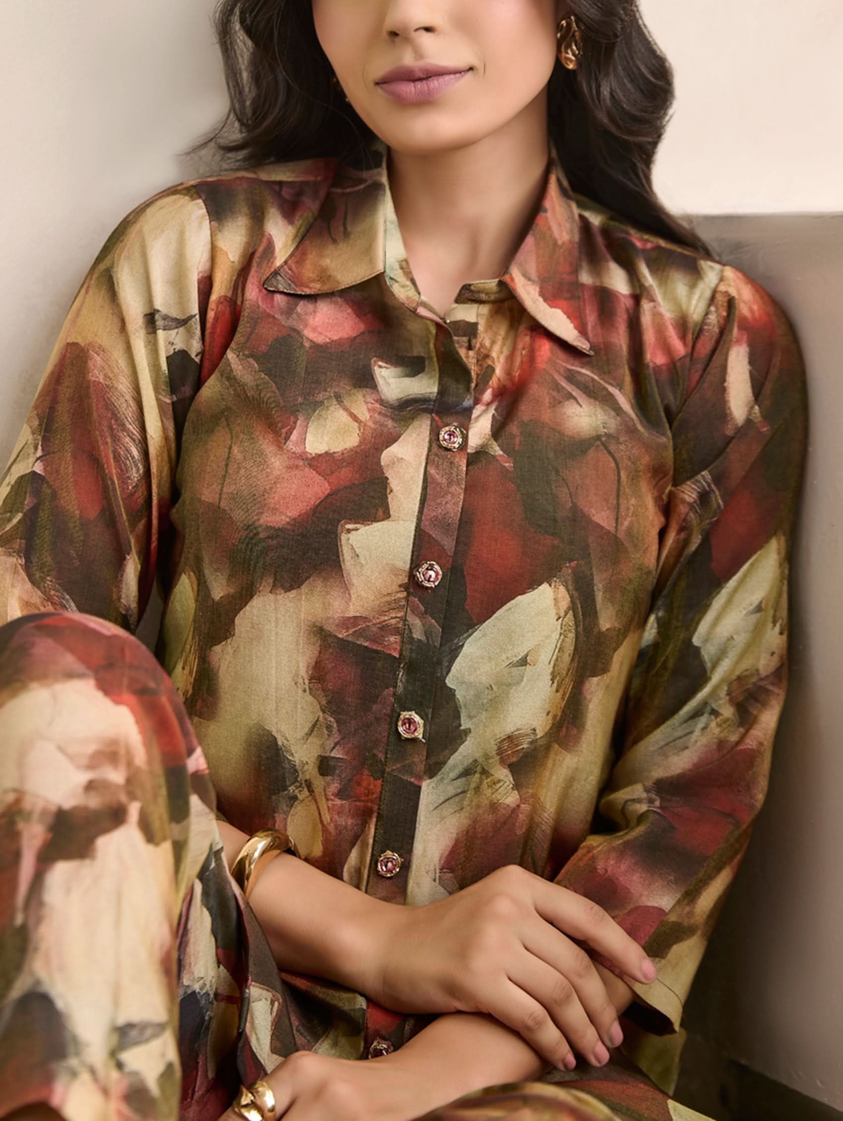 Woman wearing a patterned shirt with a neutral background