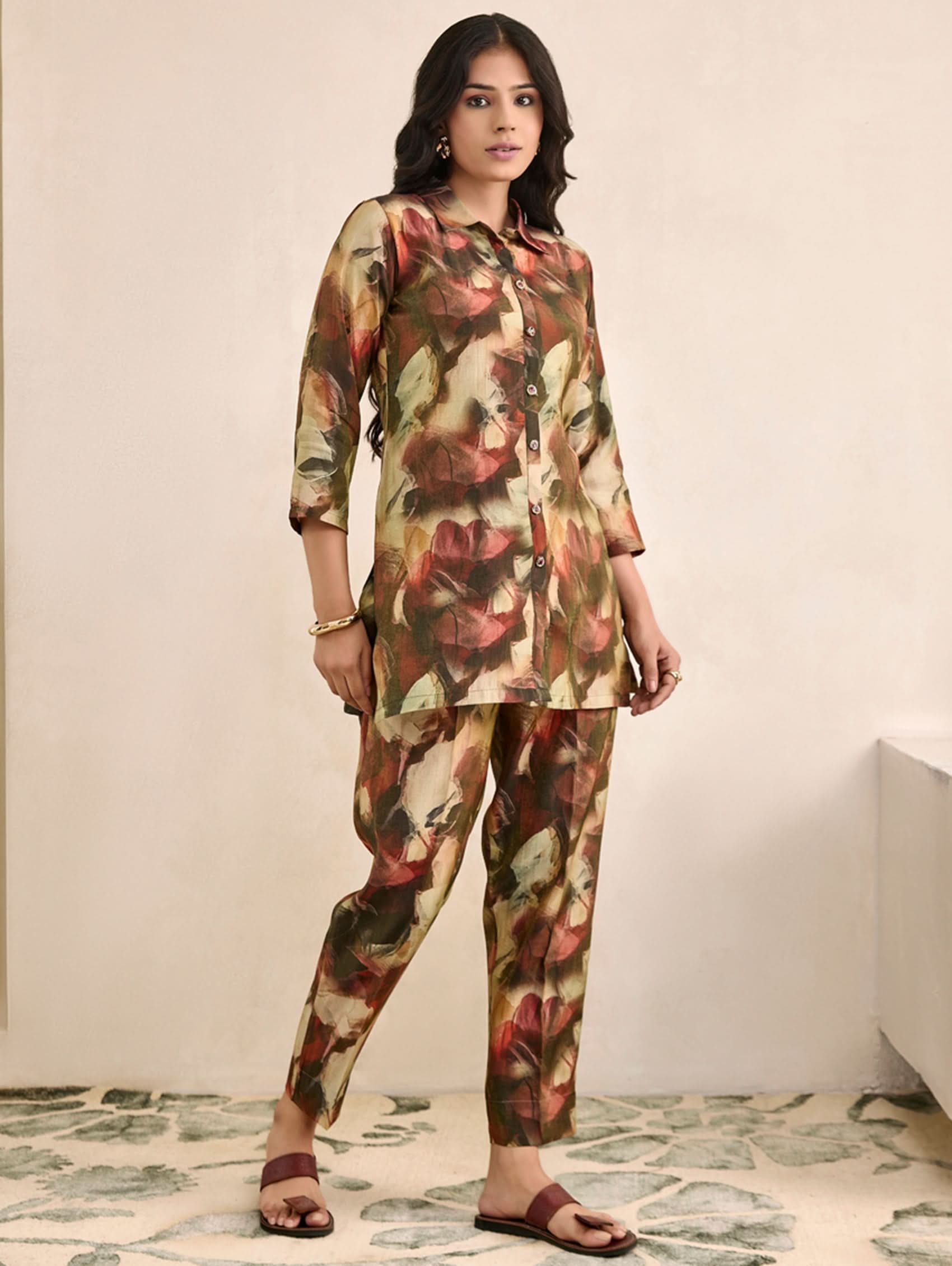 Woman wearing a floral outfit in a minimal indoor setting