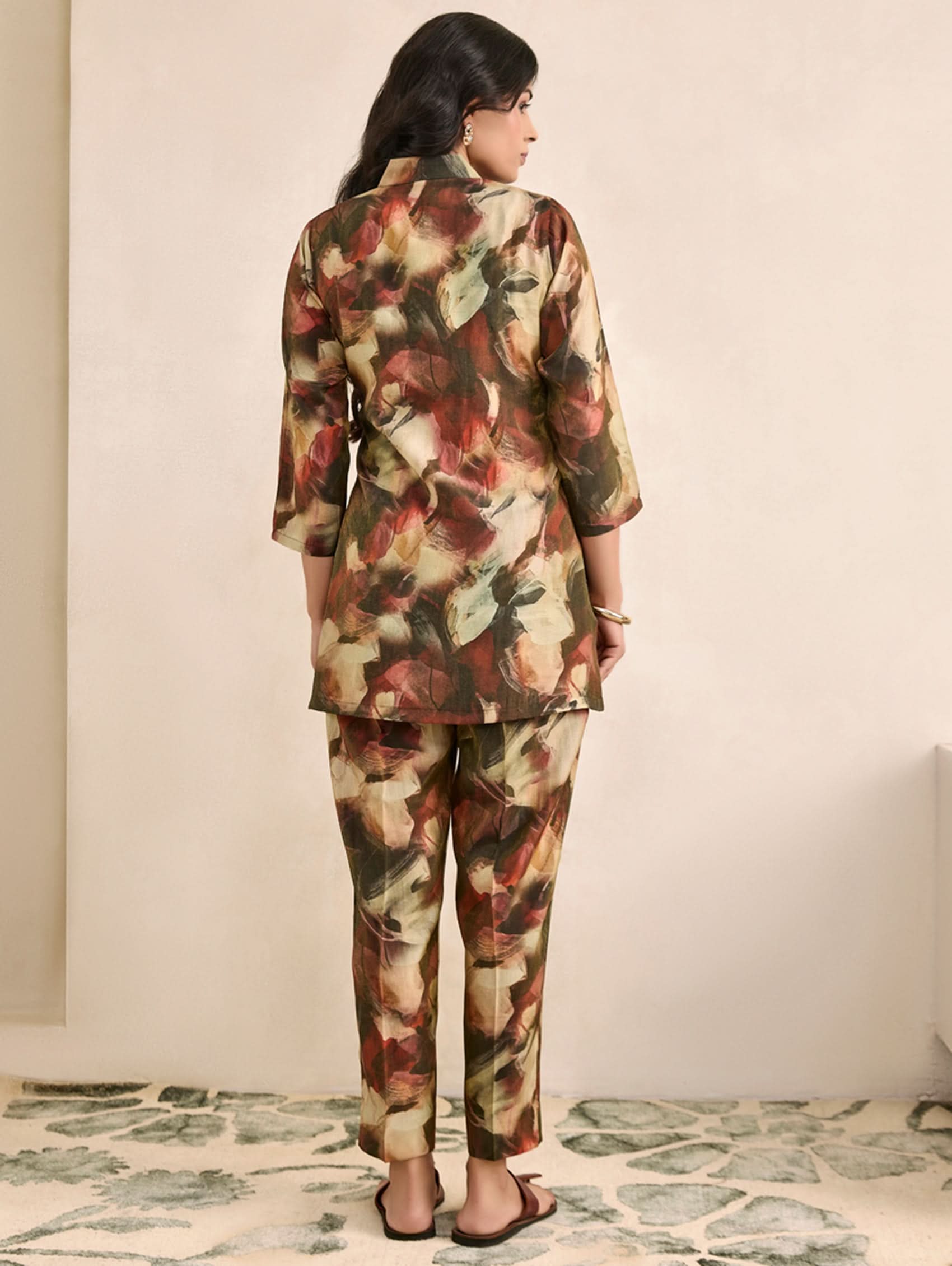 Woman wearing a floral two-piece outfit on a neutral background