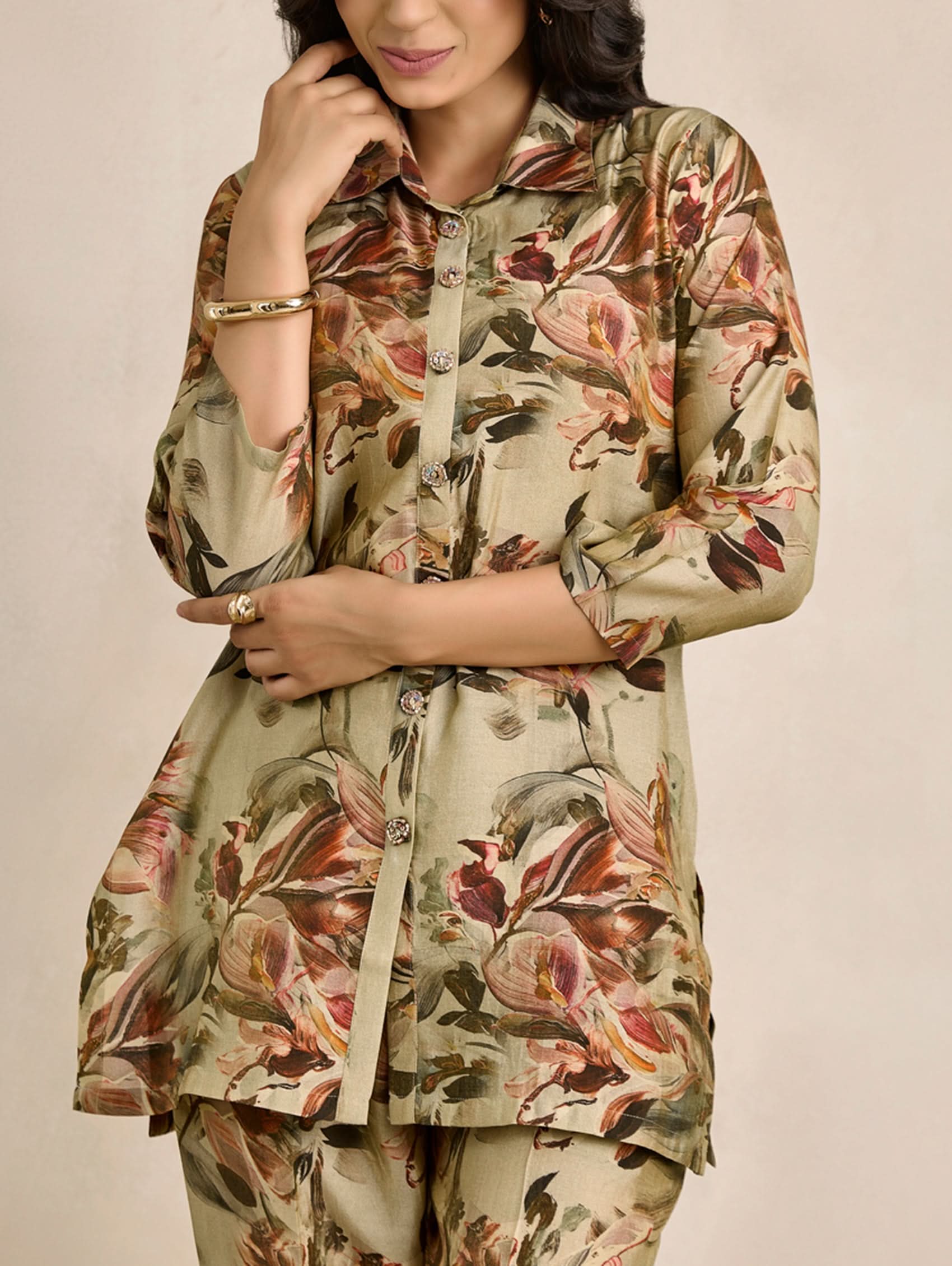 Woman wearing a floral patterned outfit on a beige background
