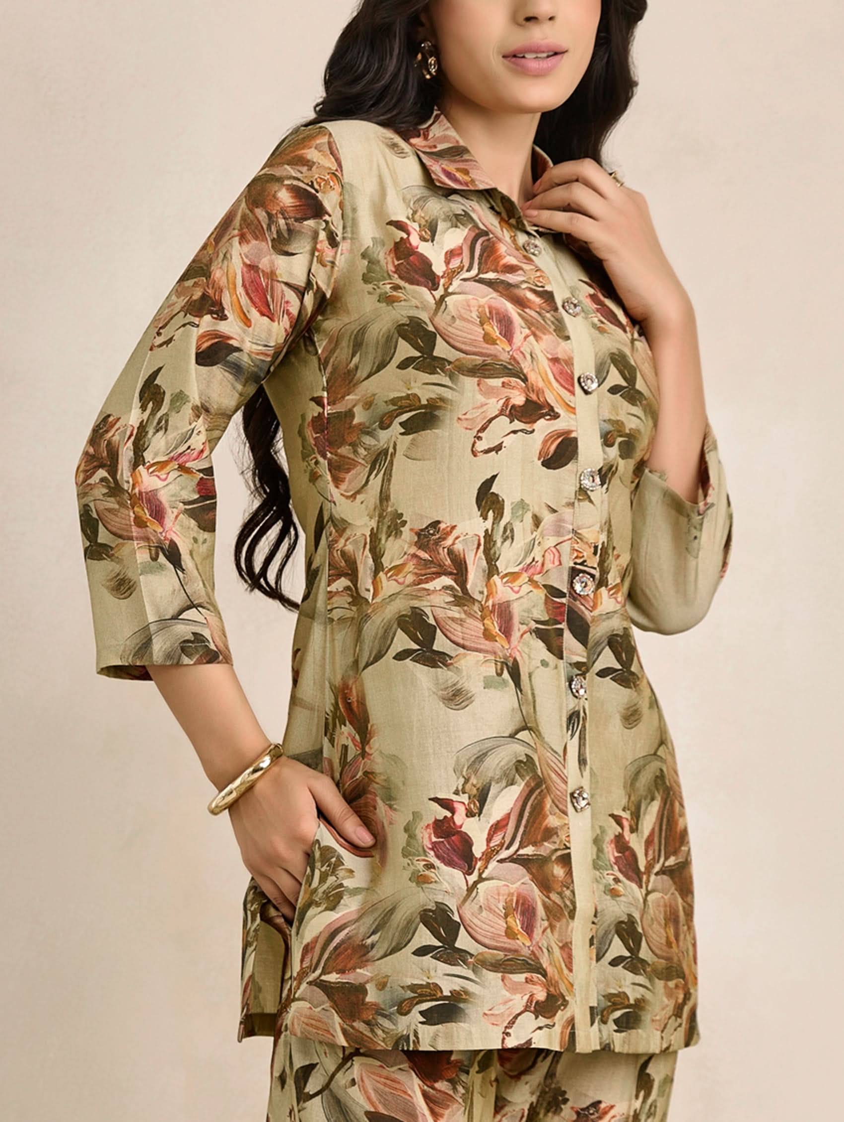 Woman wearing a floral print outfit on a beige background
