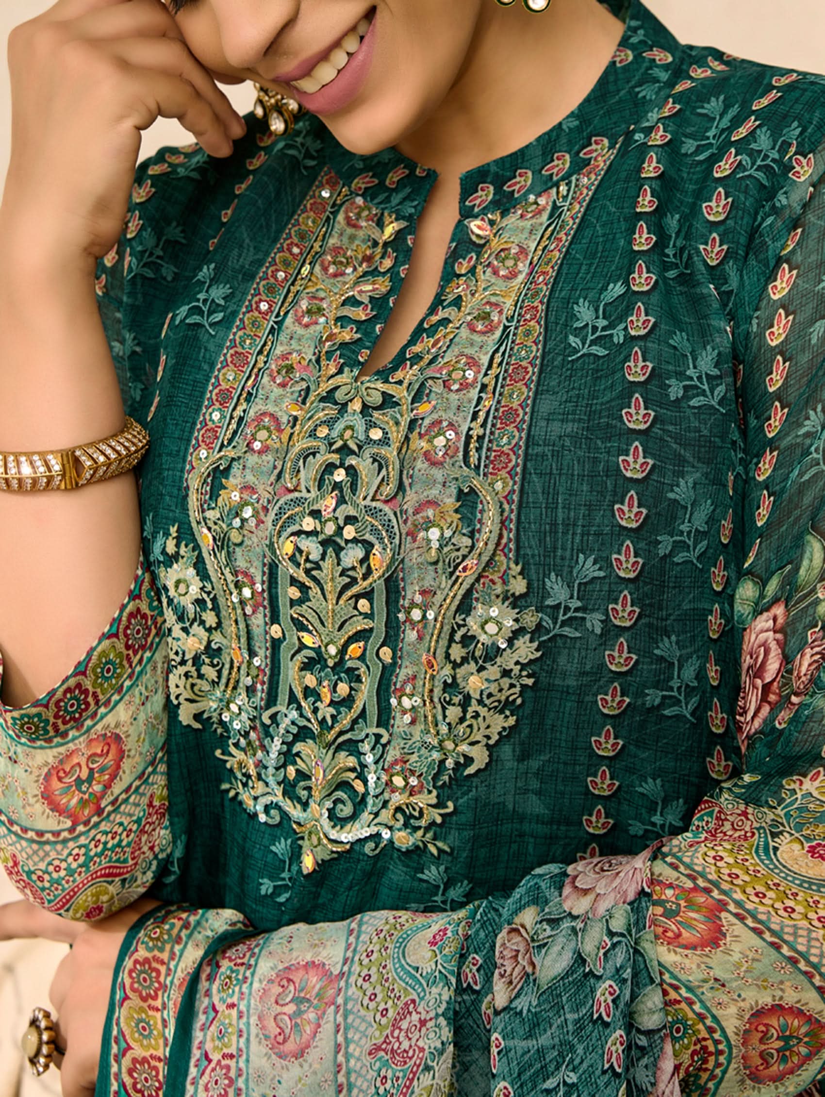 Woman wearing a traditional embroidered outfit with intricate patterns.