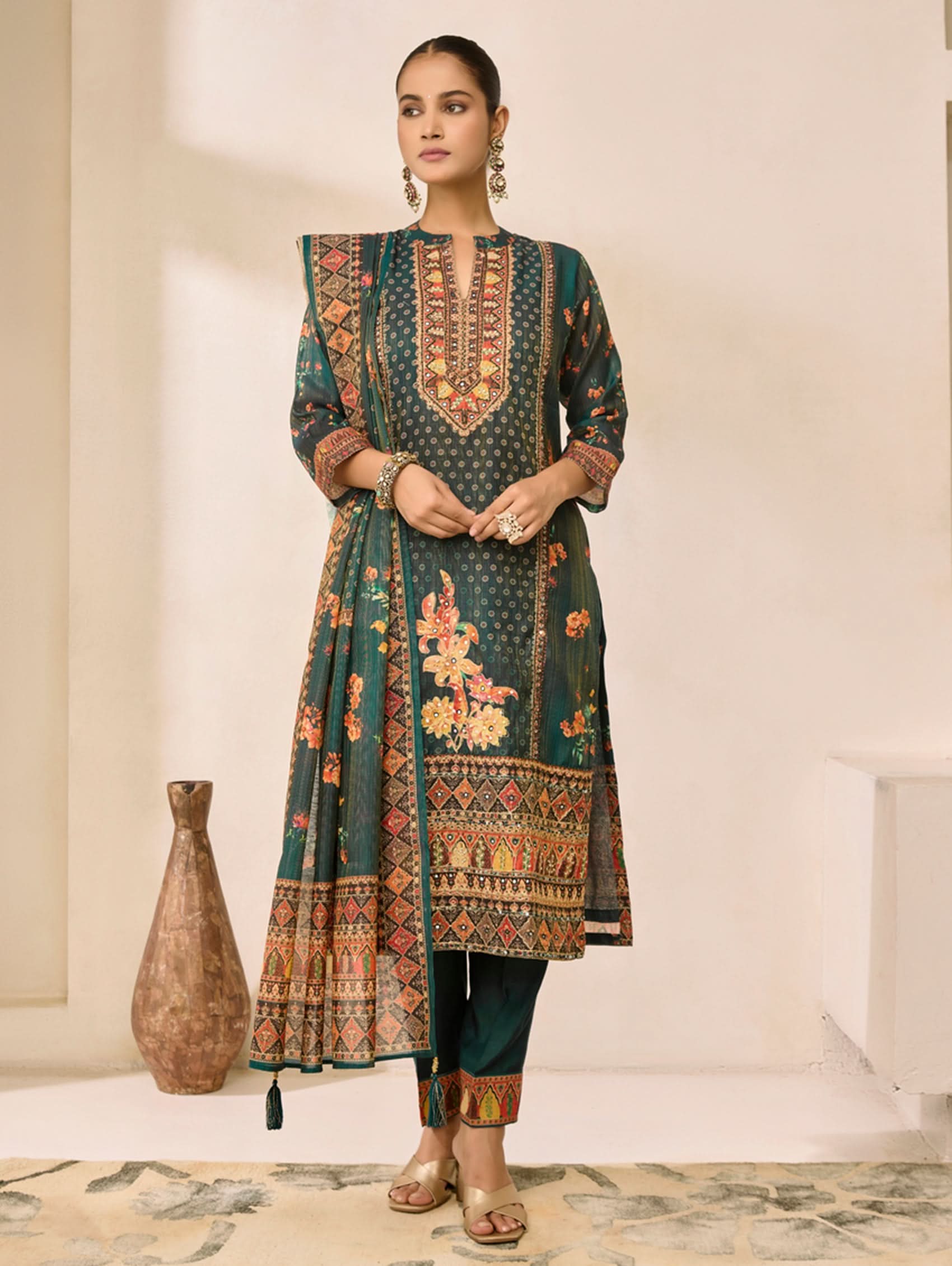 Woman wearing a traditional embroidered outfit in a minimalistic setting