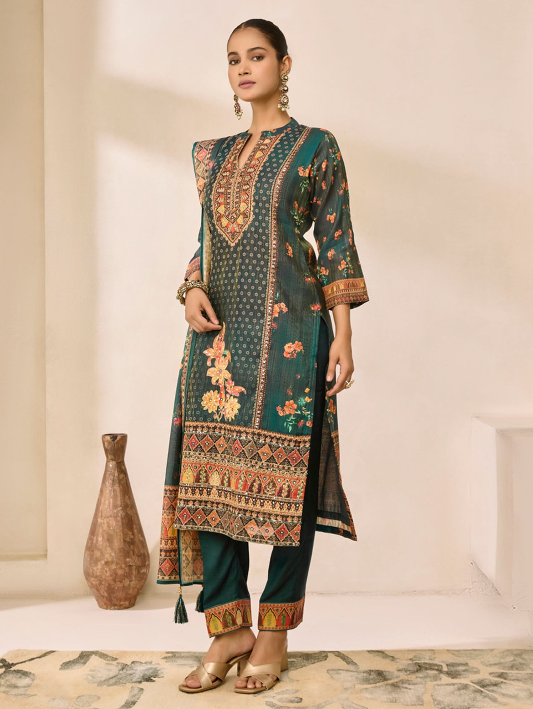 Woman wearing a traditional outfit with floral patterns in a minimalistic setting