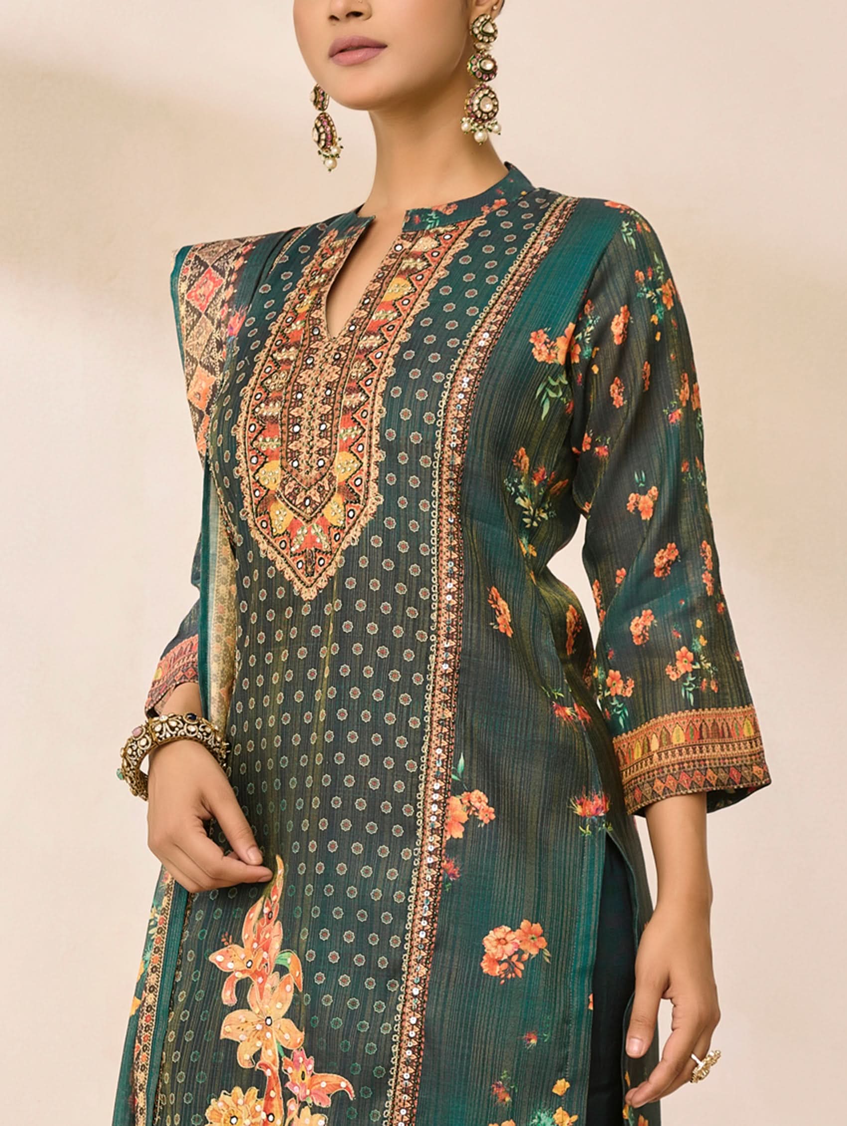 Green patterned kurta with floral designs on a neutral background
