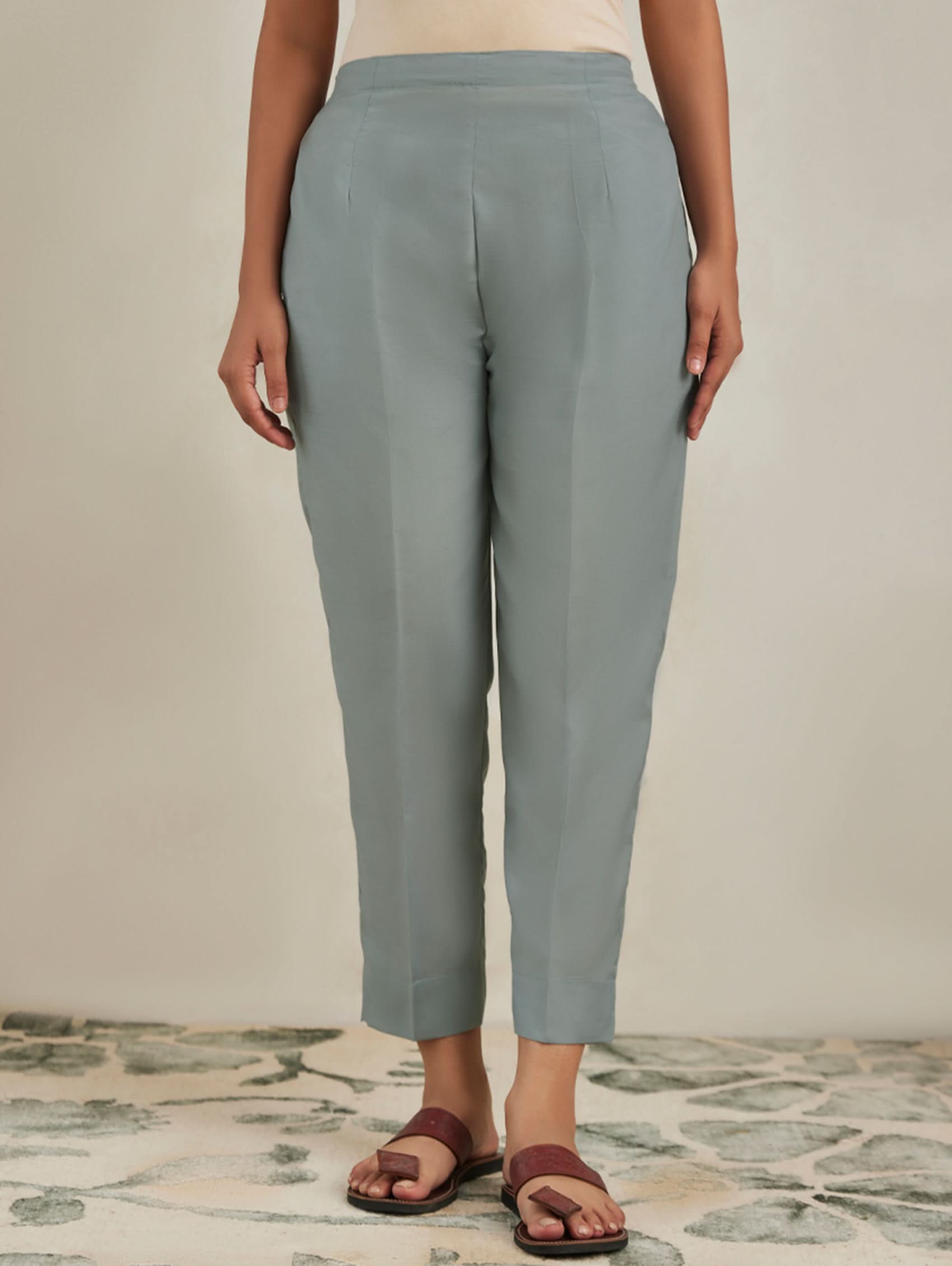 Person wearing light blue pants on a neutral background