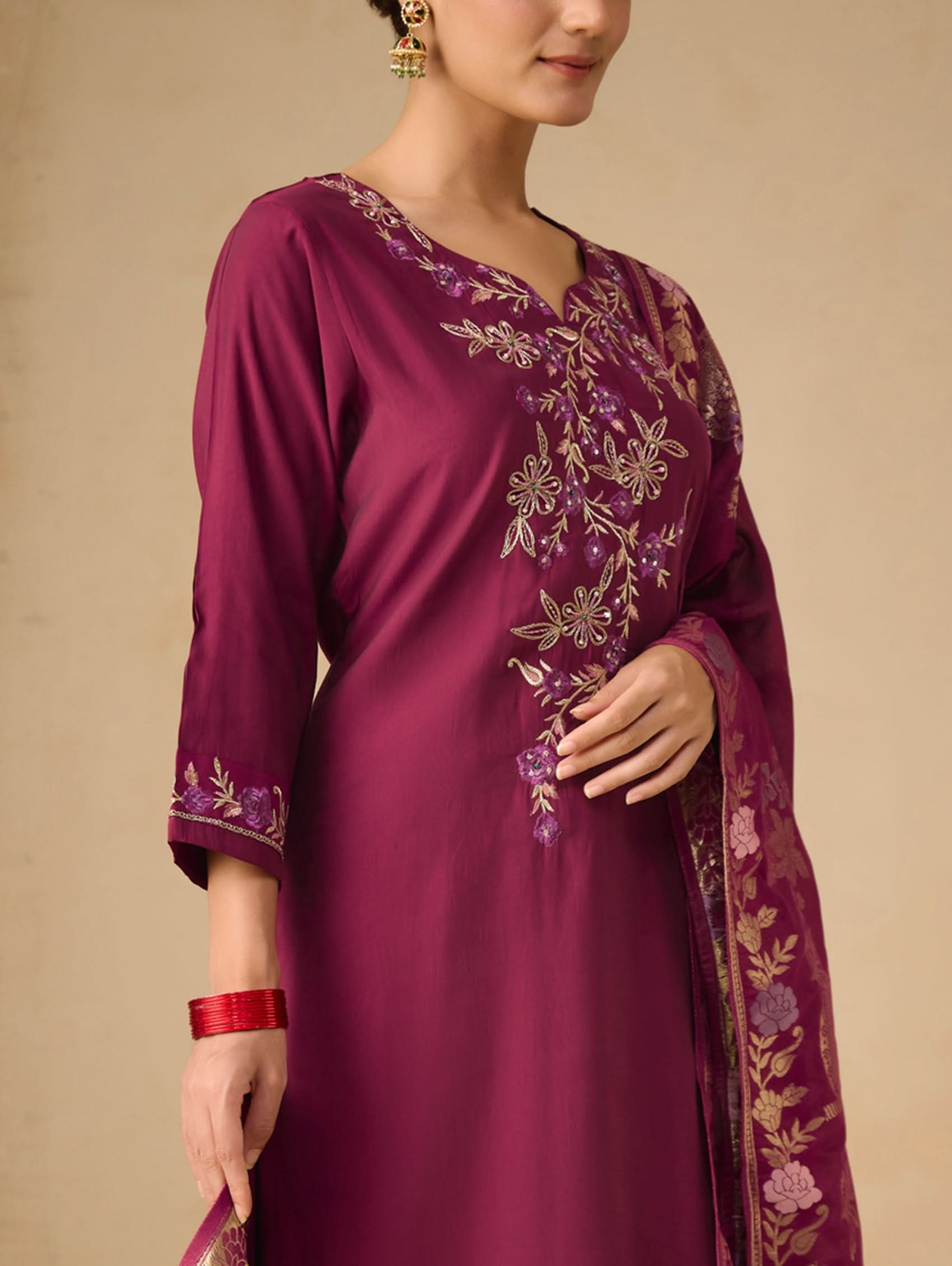 Purple embroidered dress on a beige background