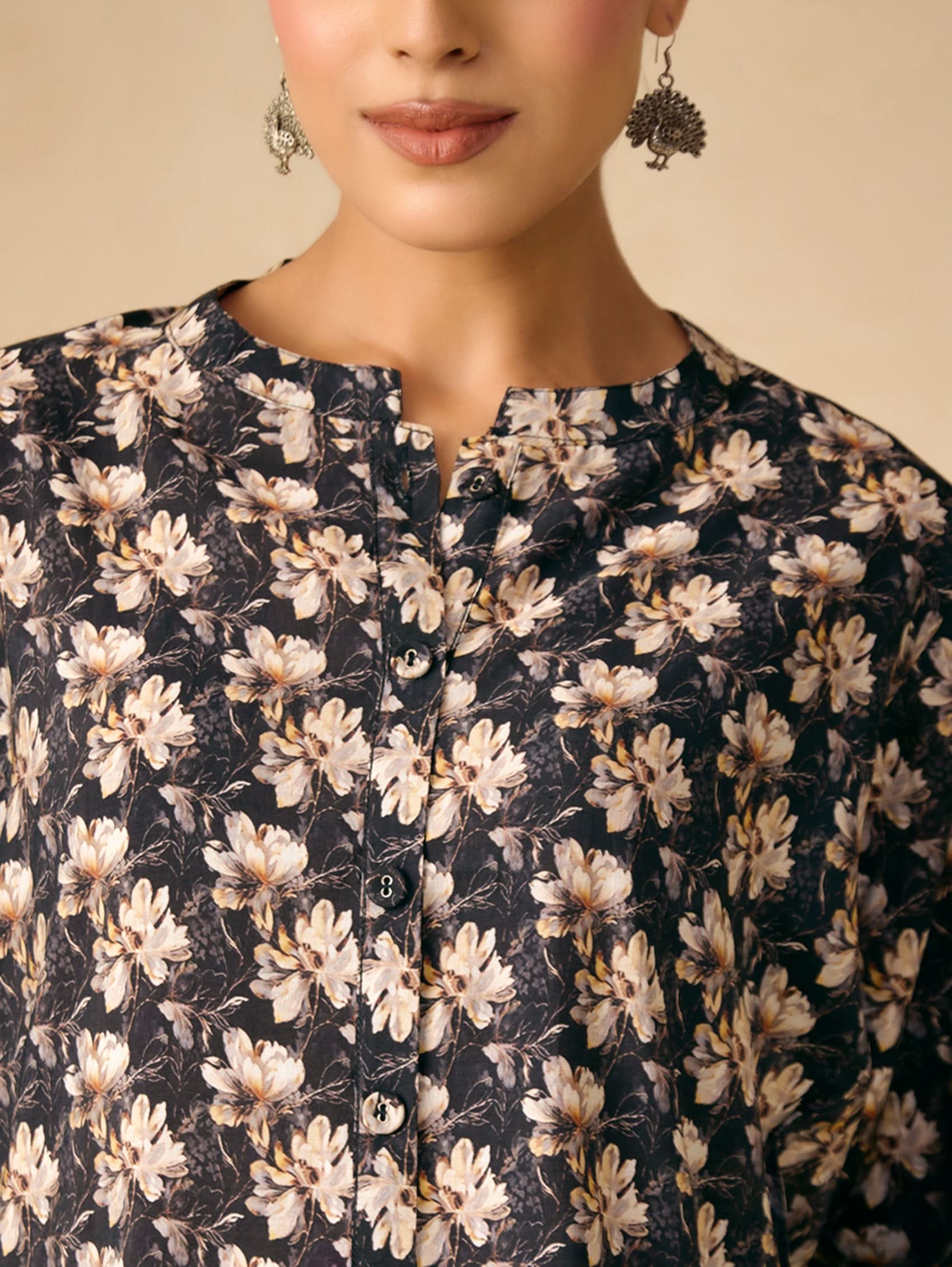 Woman wearing a floral dress with a neutral background