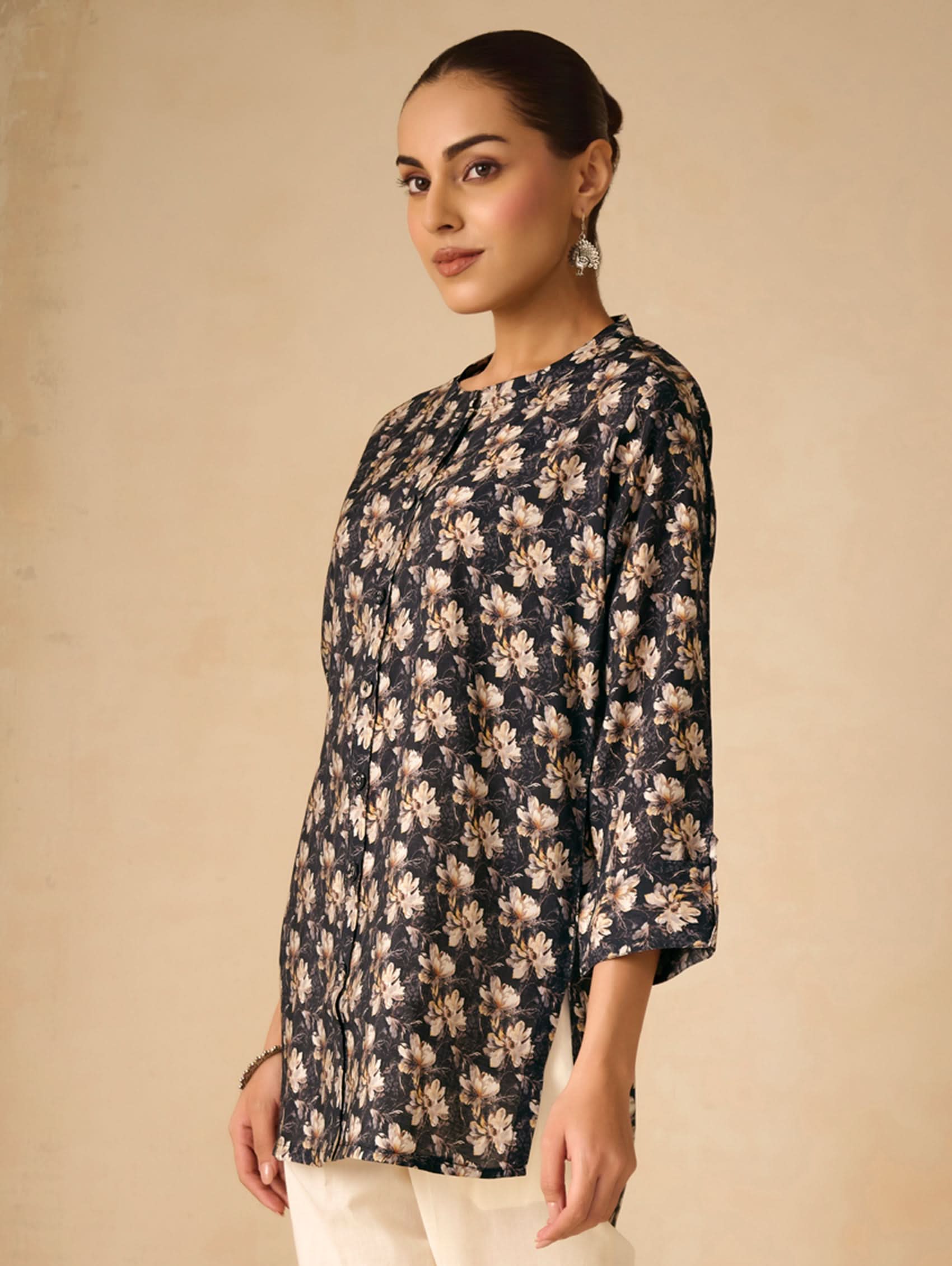 Woman wearing a floral blouse against a beige background