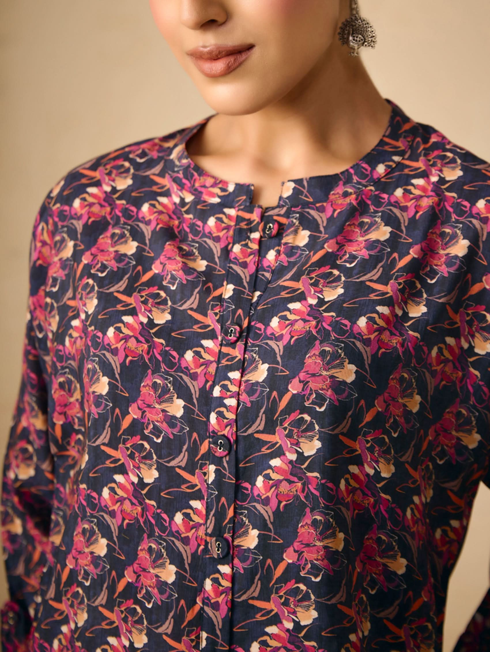 Floral patterned shirt worn by a person with a neutral background