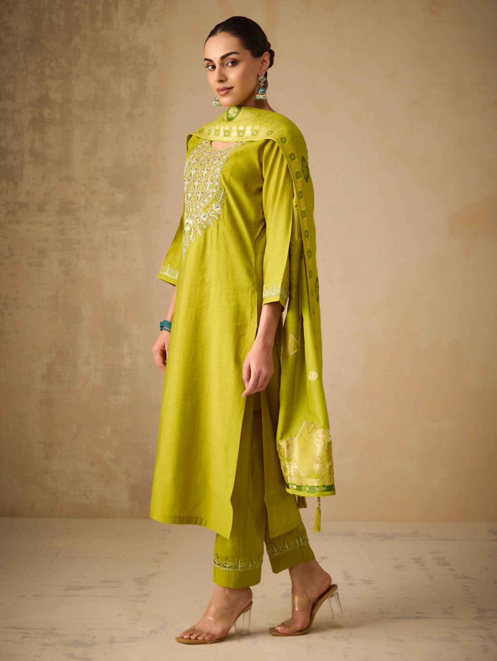 Embroidered lime-green suit set with draped dupatta and gold border details