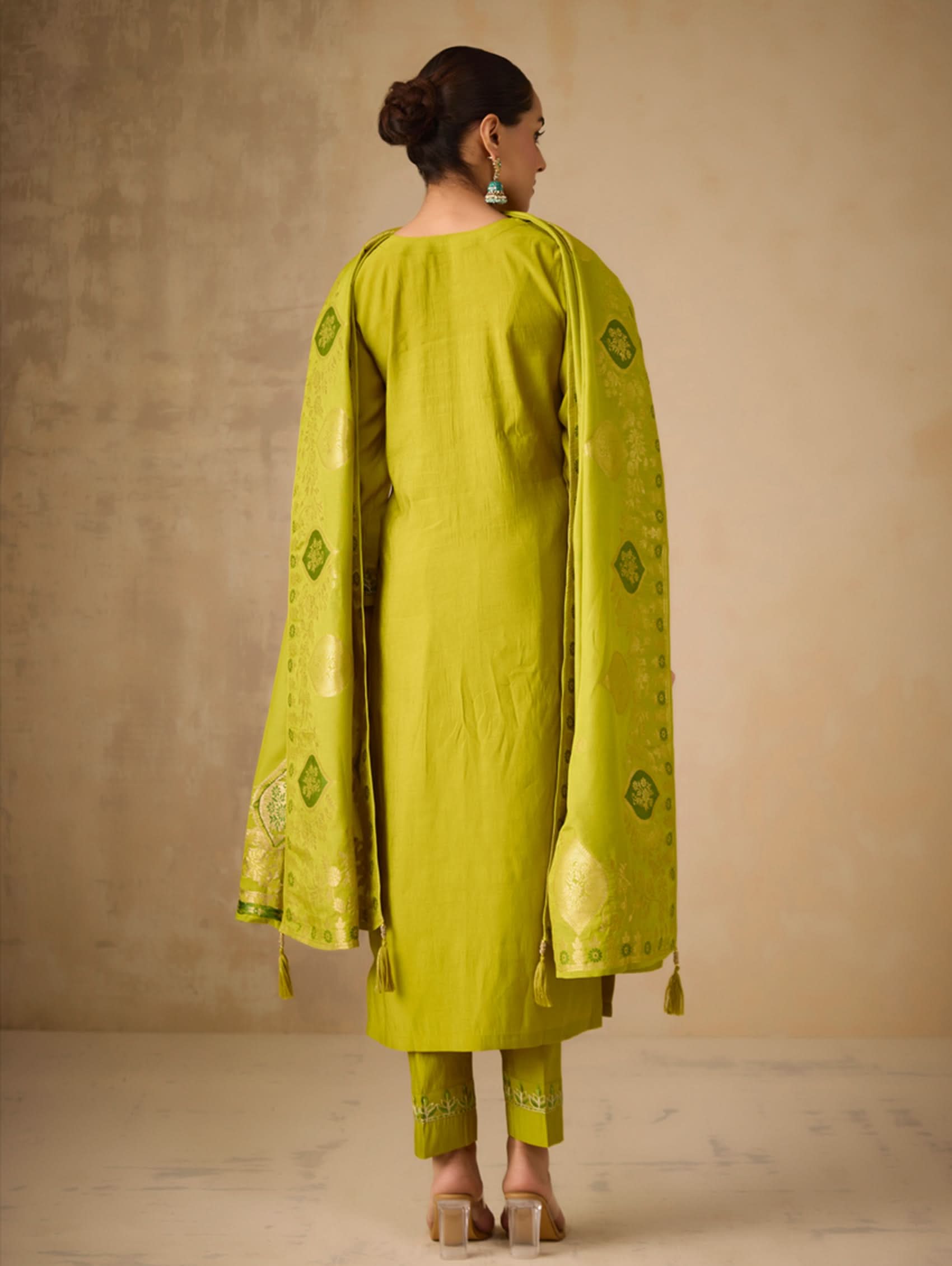 Embroidered lime-green suit set with gold back motifs and tasseled dupatta
