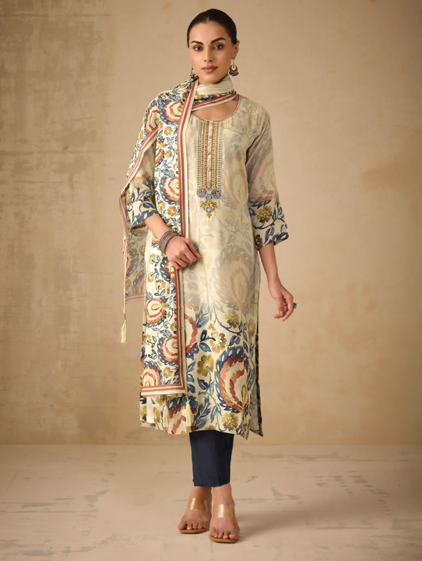 Woman wearing a patterned kurta with a plain background