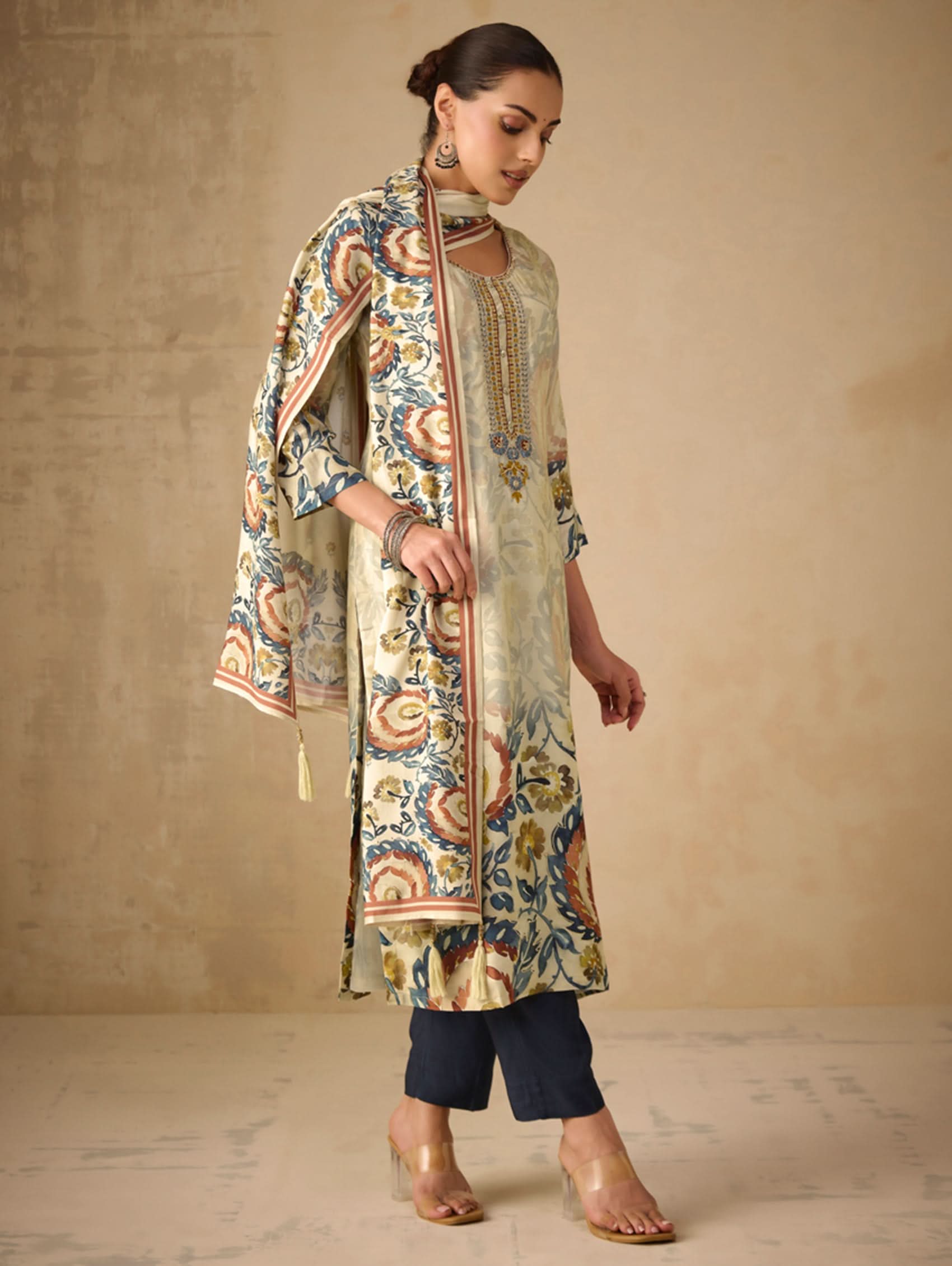 Woman wearing a patterned kurta with a plain background