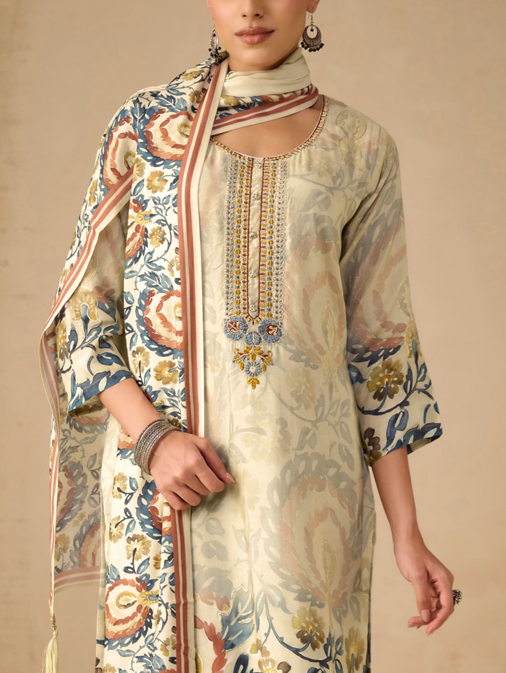 Traditional outfit with embroidered design on a beige background