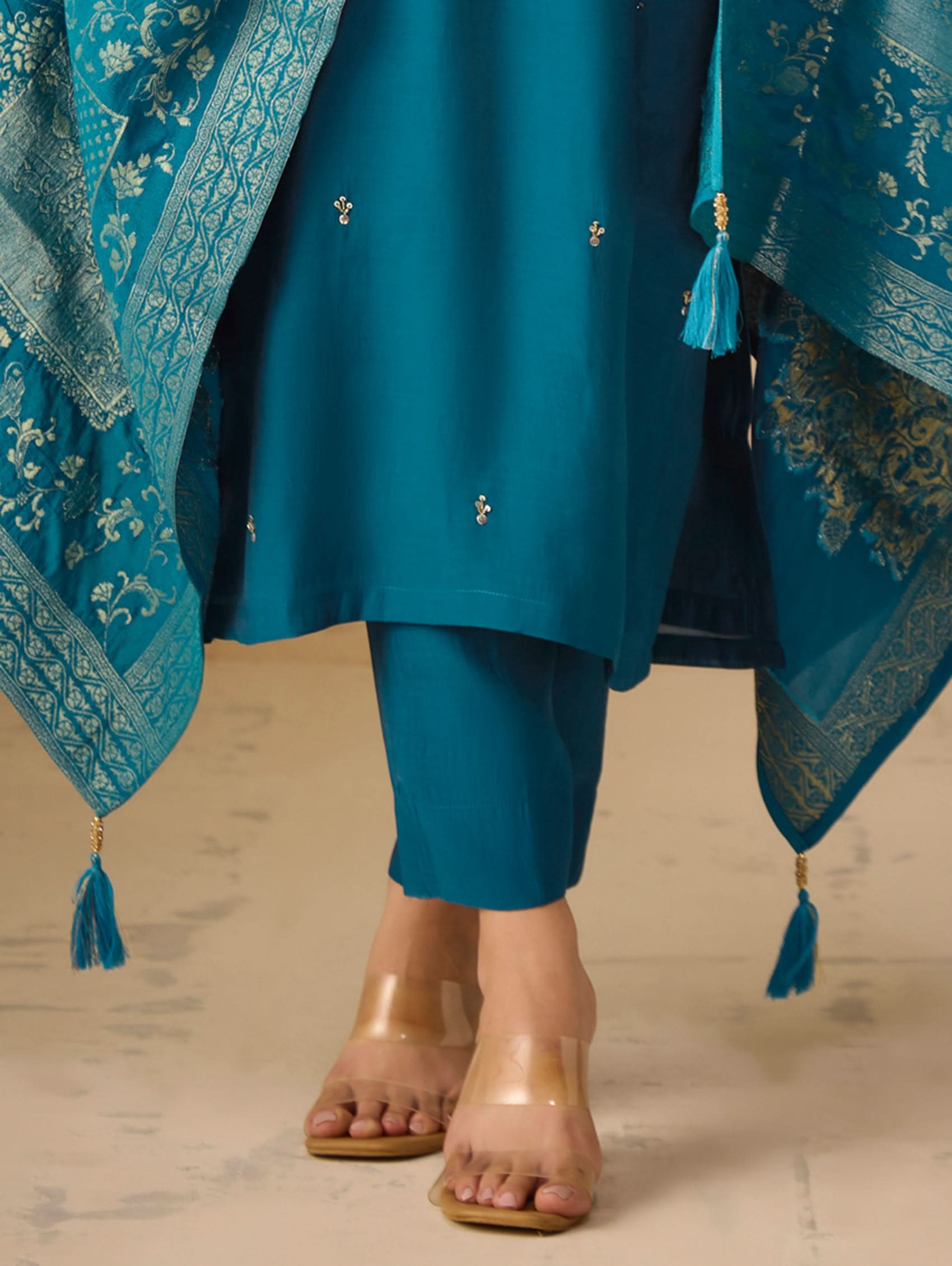 Teal traditional outfit with matching dupatta on a neutral background