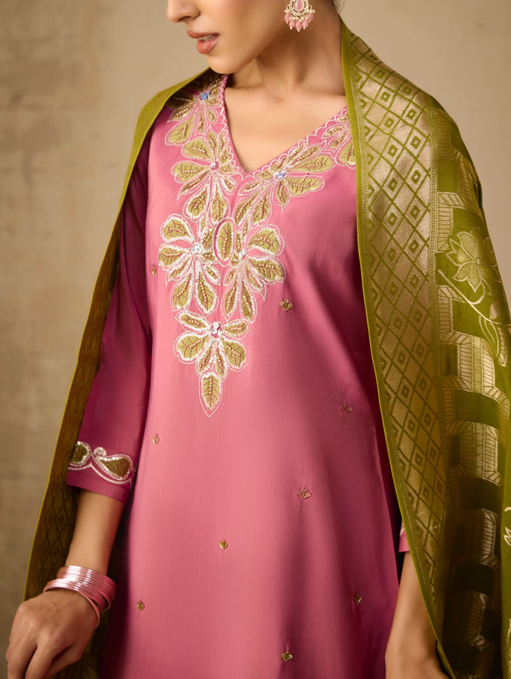 Pink embroidered dress with green dupatta on a neutral background