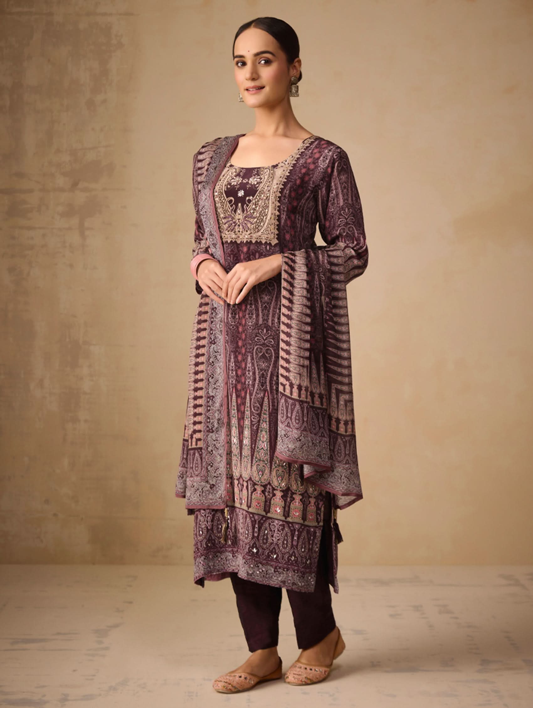 Woman wearing a patterned dress with a plain background