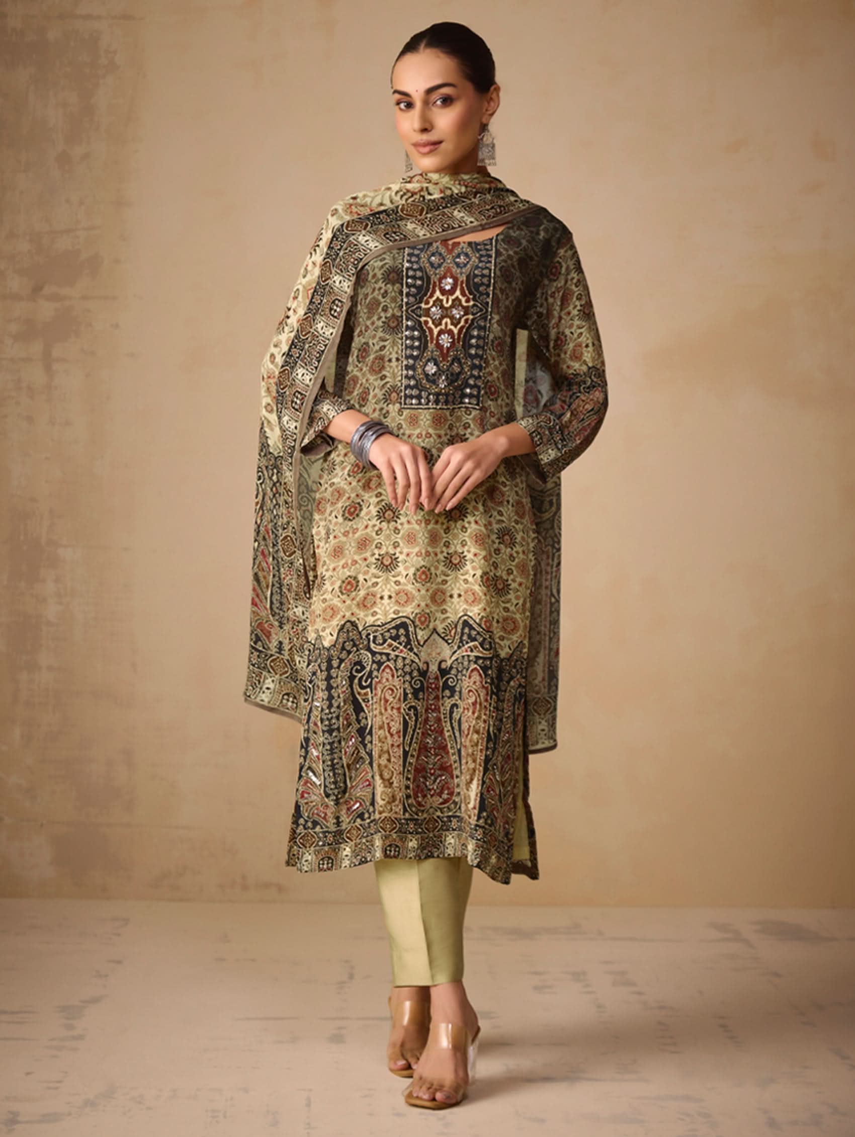 Woman wearing a patterned kurta with a plain background
