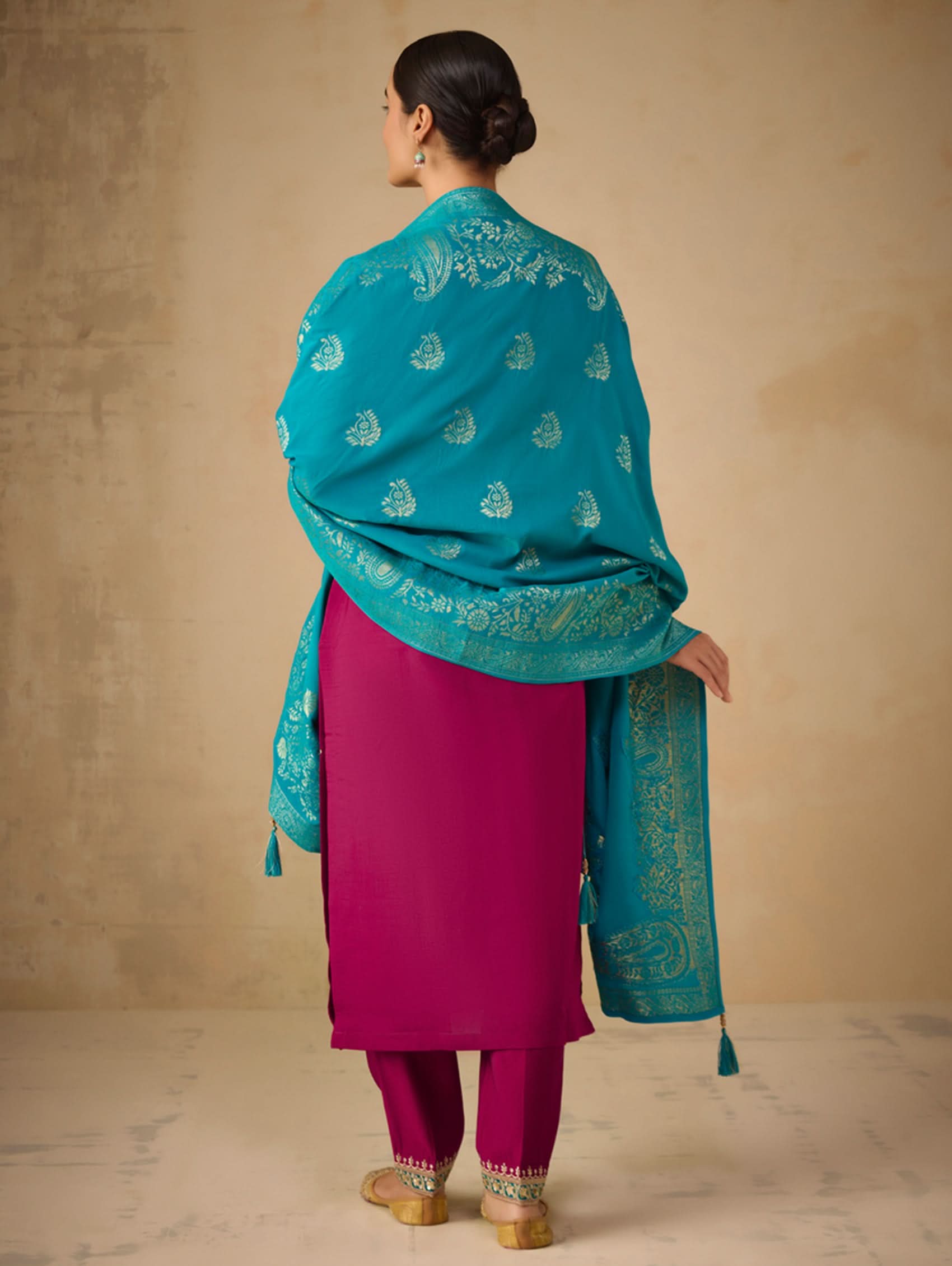 Back view of embroidered berry suit set with teal dupatta and gold motifs