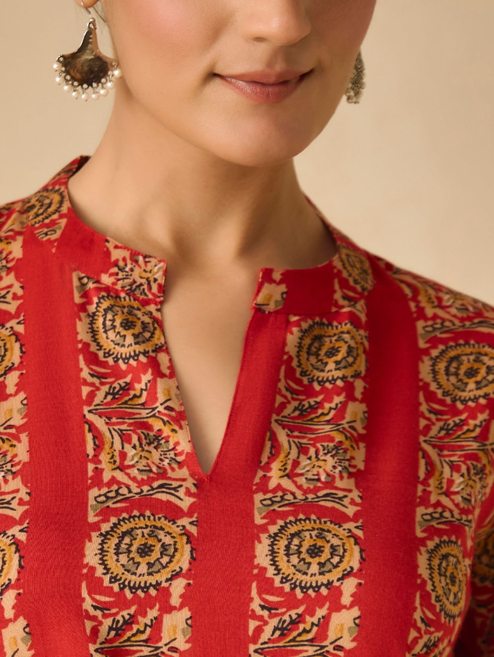 Red patterned blouse with a close-up of a woman wearing it.