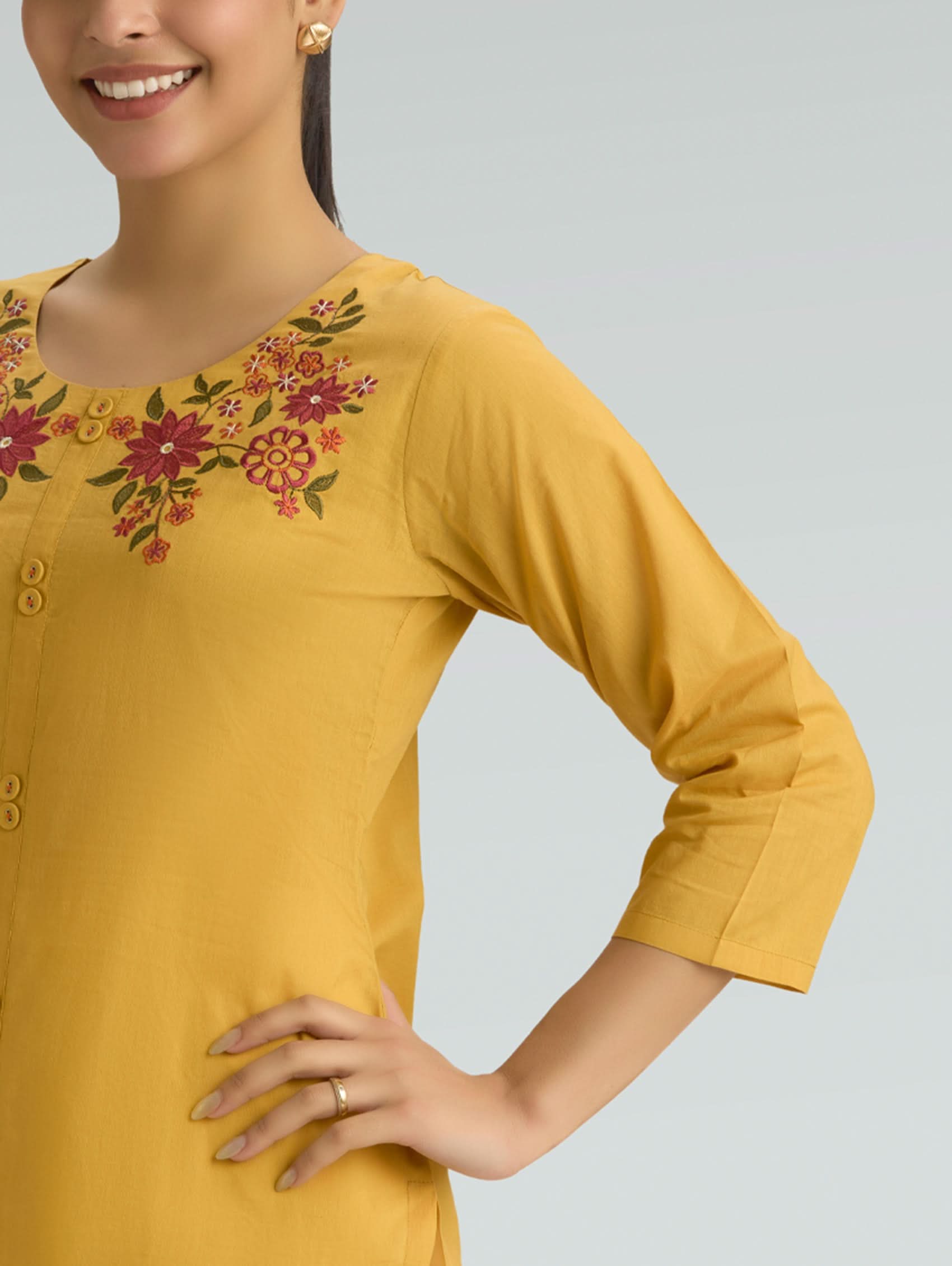 Yellow kurta with floral embroidery on a plain background