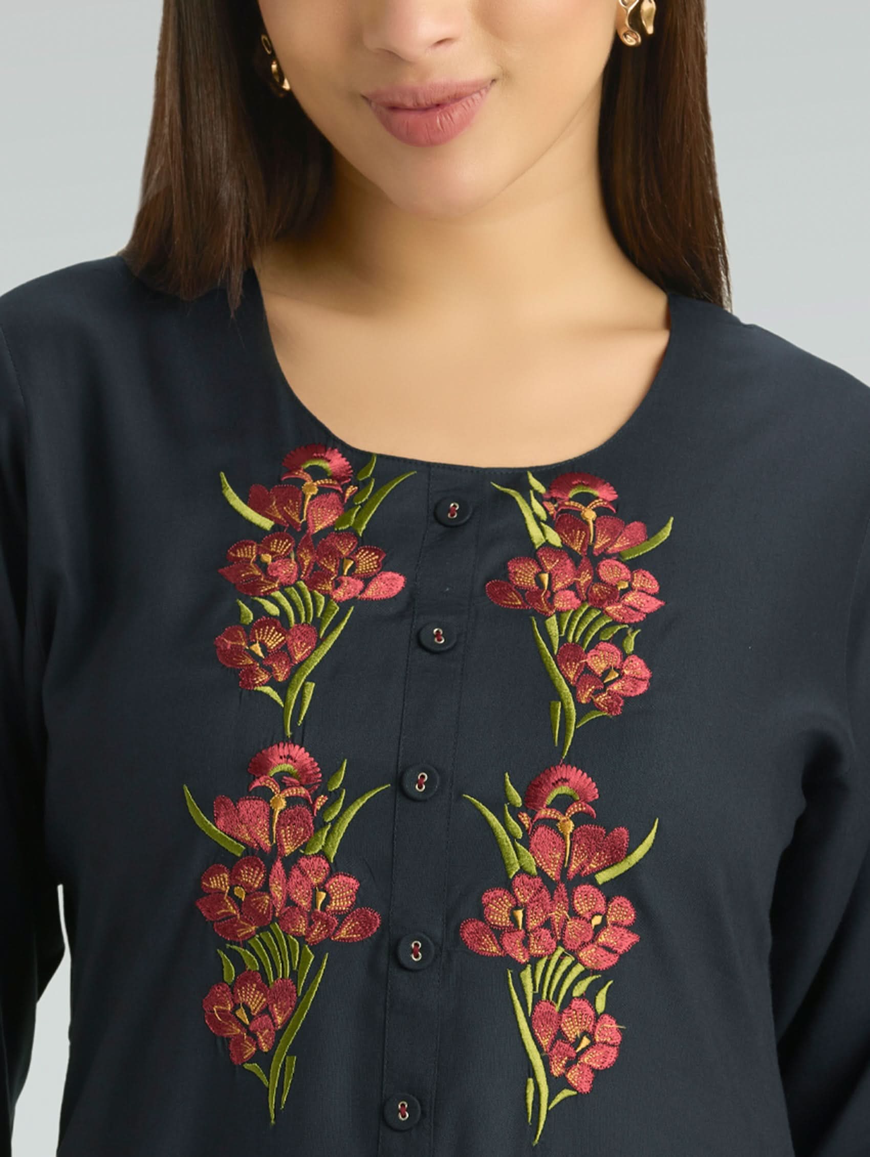Navy blue top with floral embroidery on a plain background
