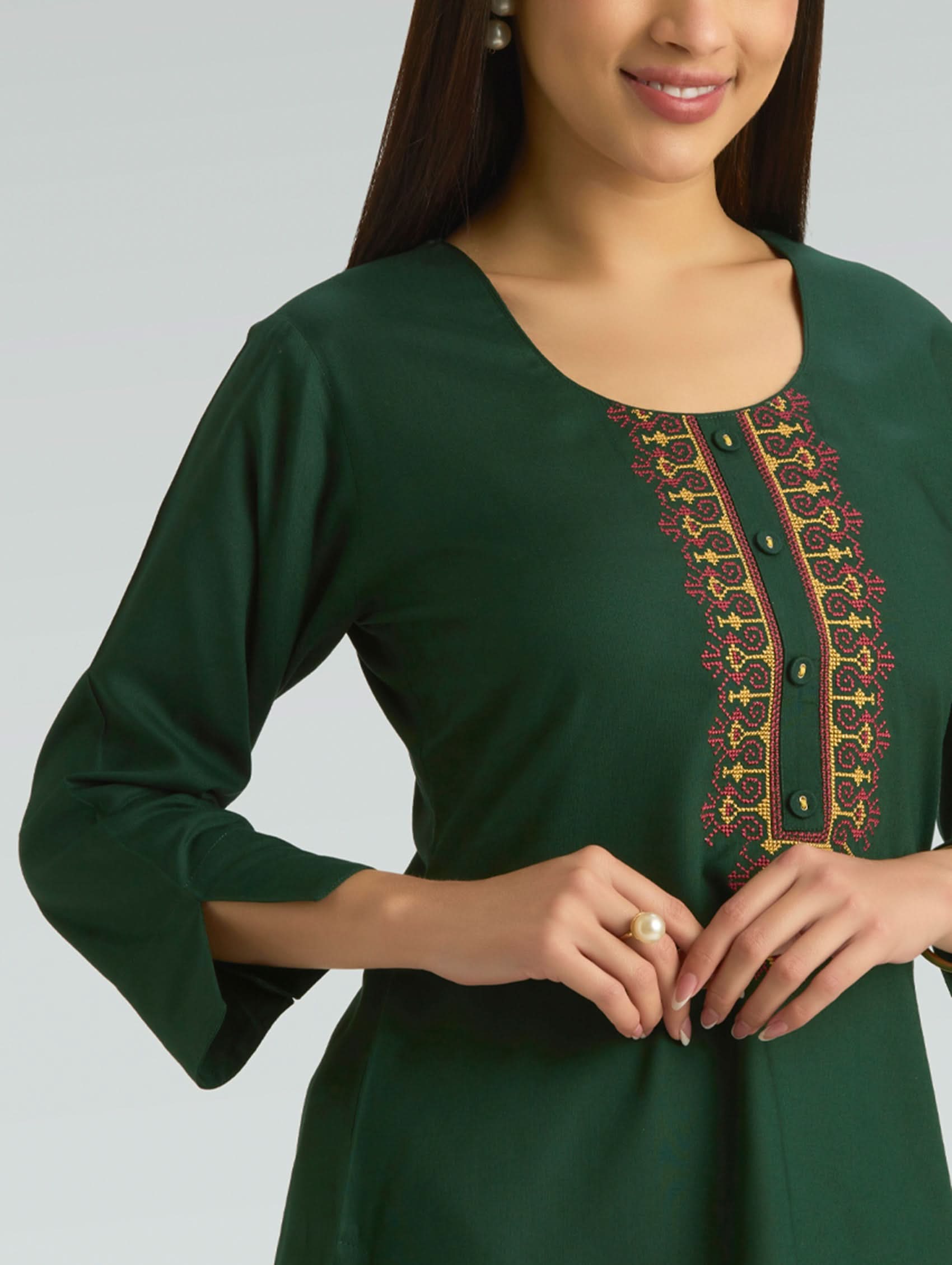 Green dress with embroidery on a plain background
