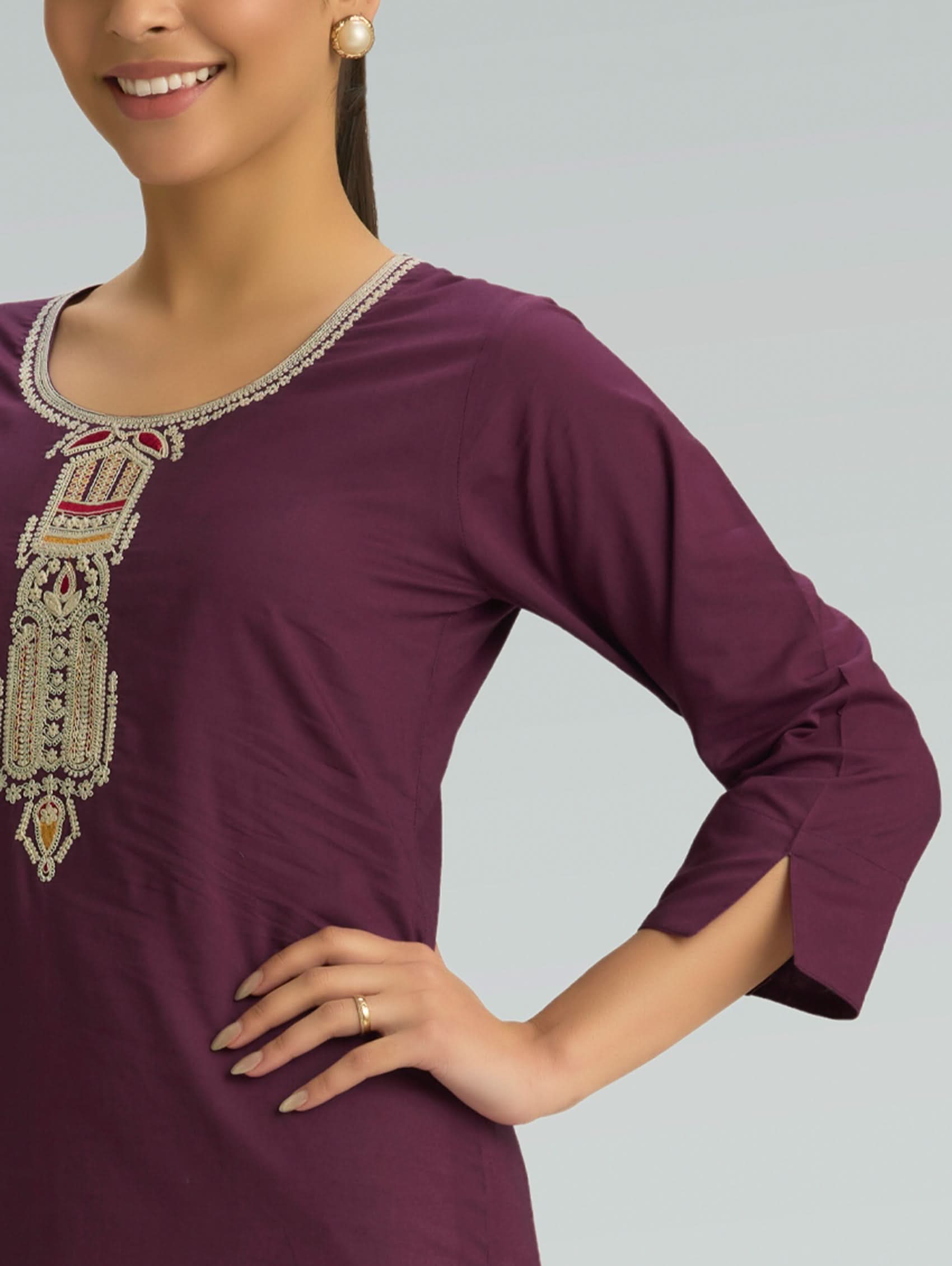 Purple dress with intricate beading on a plain background