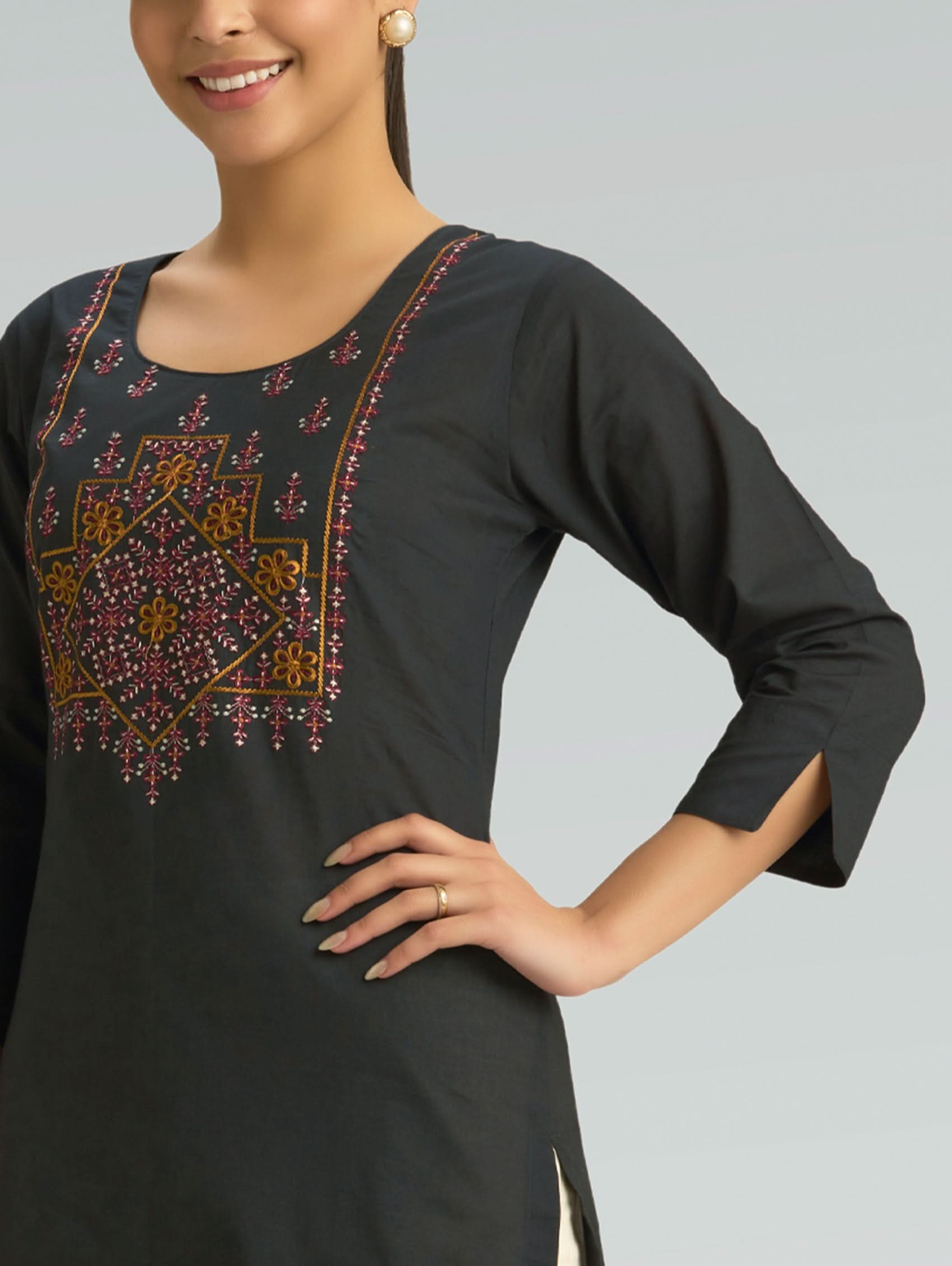 Black kurta with intricate embroidery on a plain background