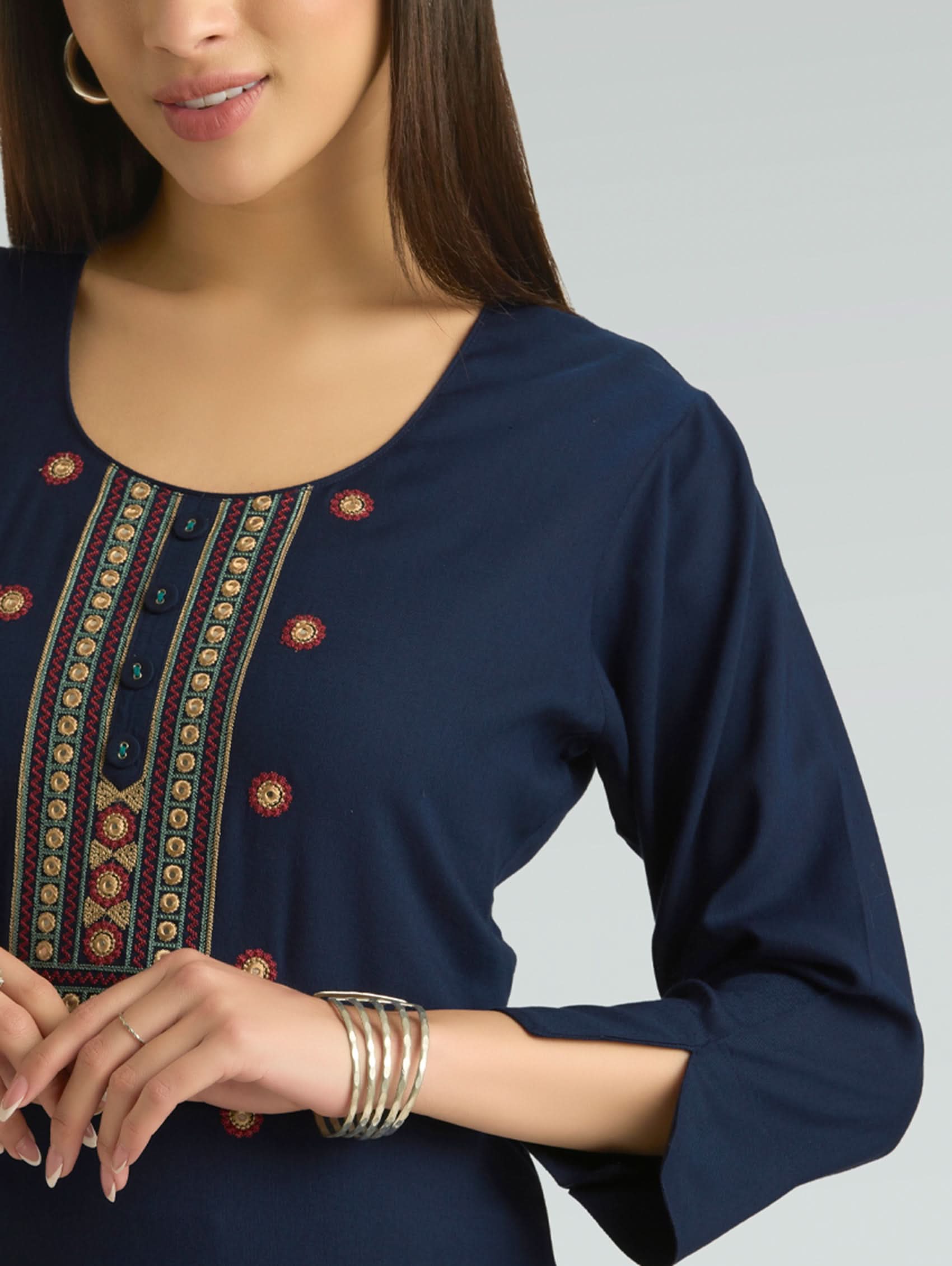 Navy blue top with intricate patterns on a plain background