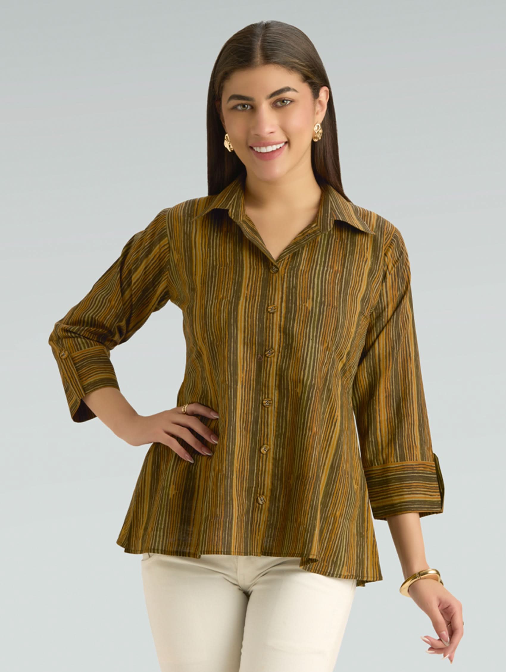Woman wearing a brown striped shirt against a gray background