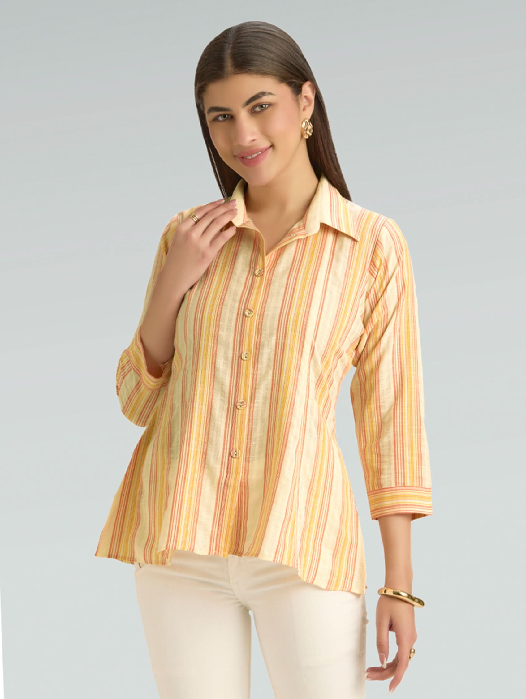 Woman wearing a striped shirt against a plain background