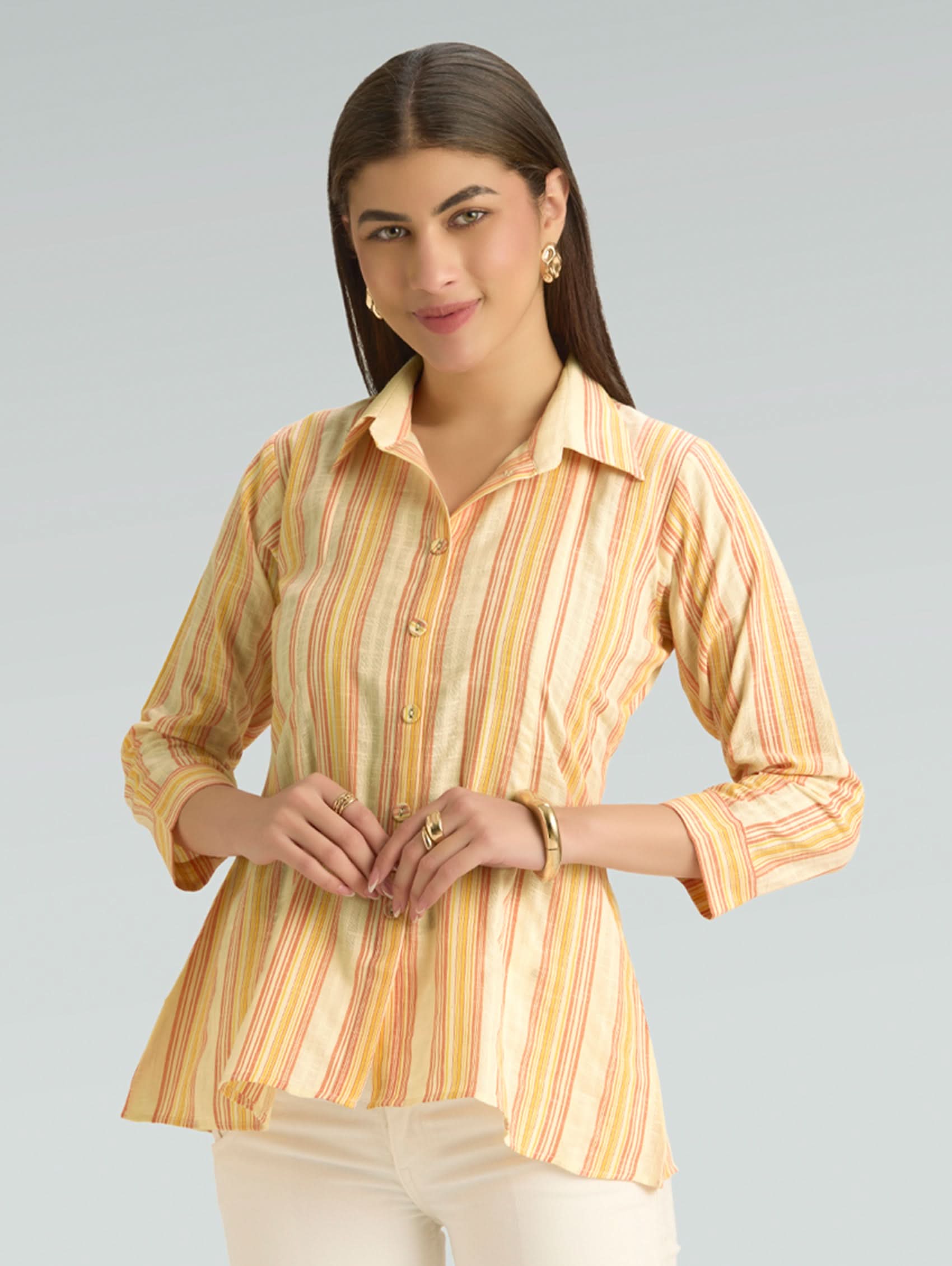 Woman wearing a striped shirt with a plain background
