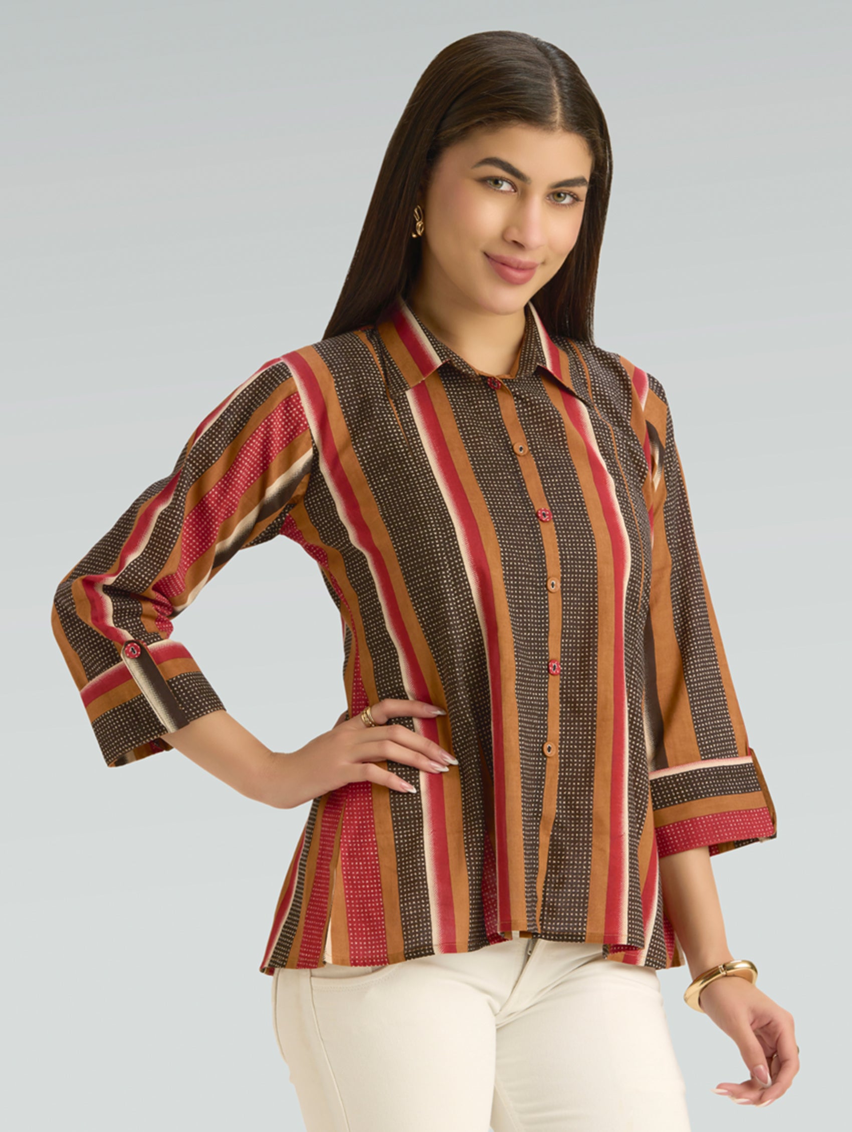 Woman wearing a patterned shirt with a plain background