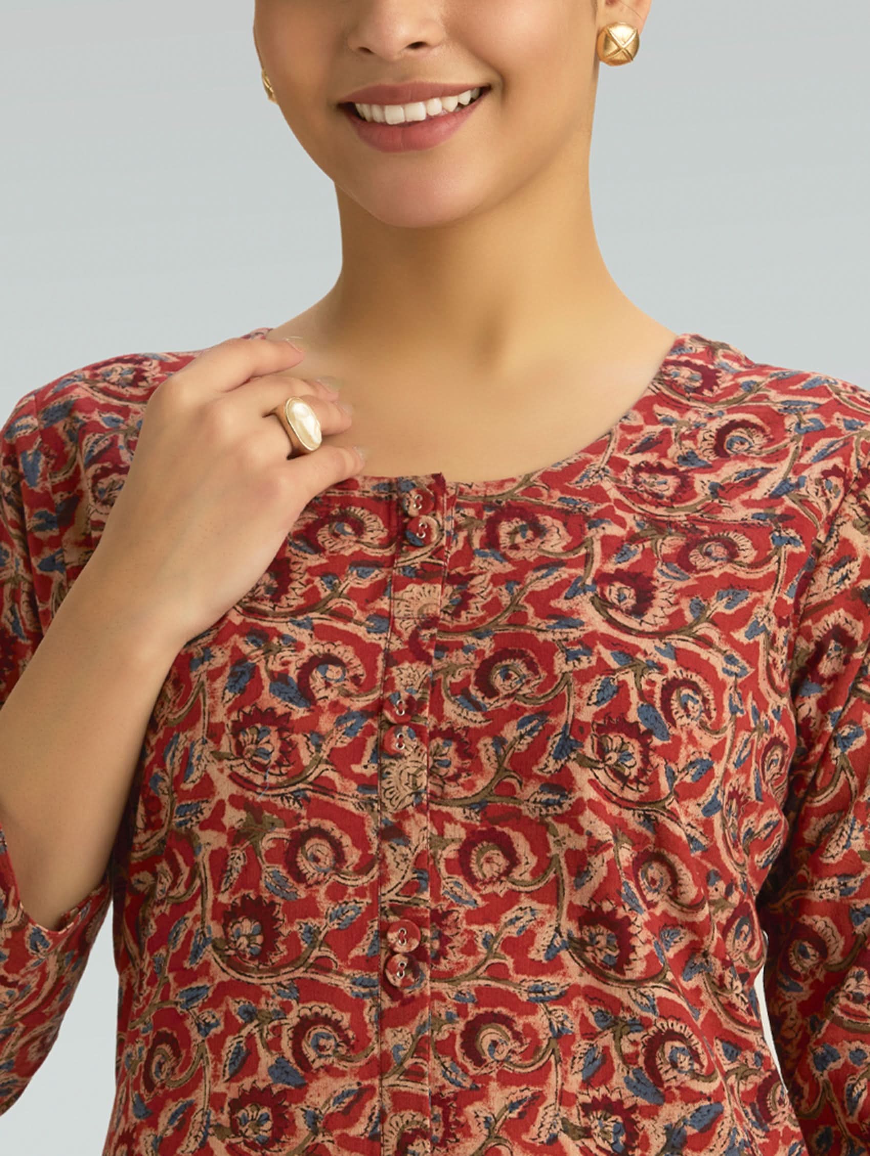 close-up of Kalamkari print and button detailing on a cotton kurta with a round neckline