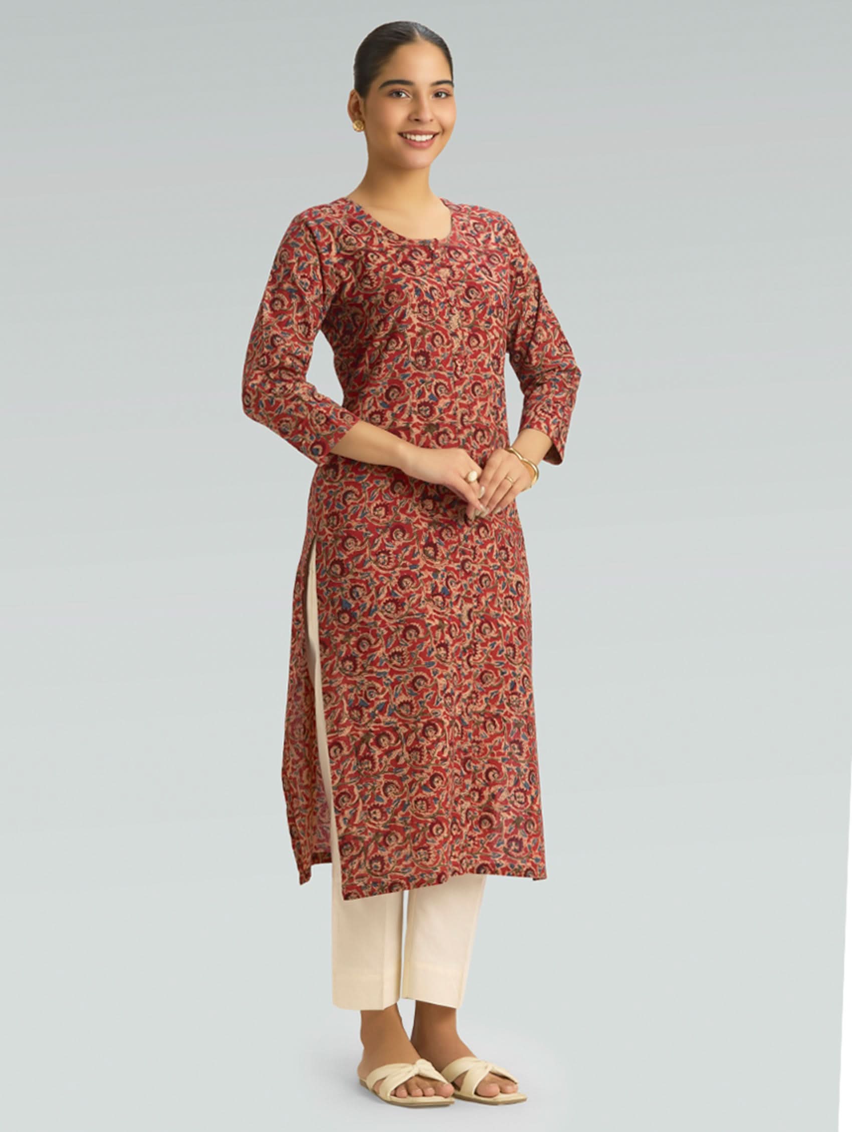 model wearing rust red Kalamkari pure cotton kurta with ivory pants