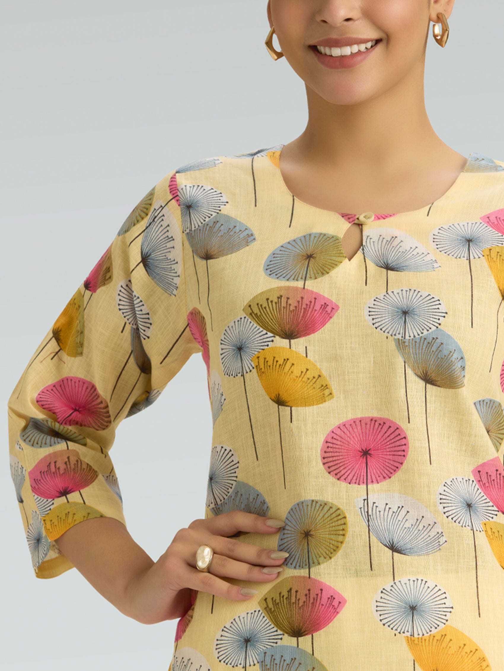 Close-up of floral print detailing on pale yellow cotton linen kurta