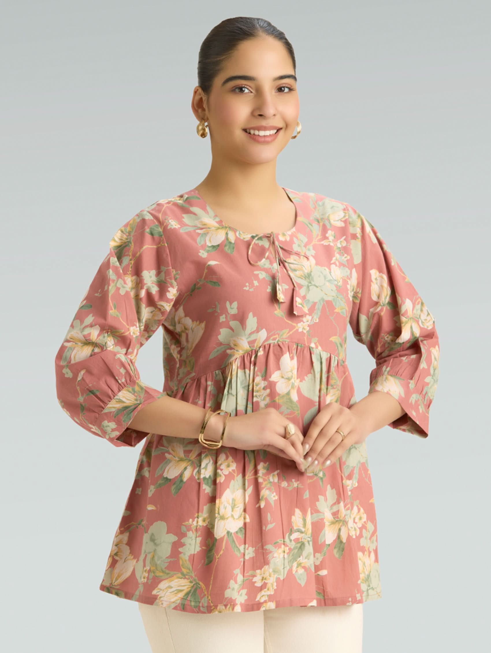 Woman wearing a floral blouse with a plain background