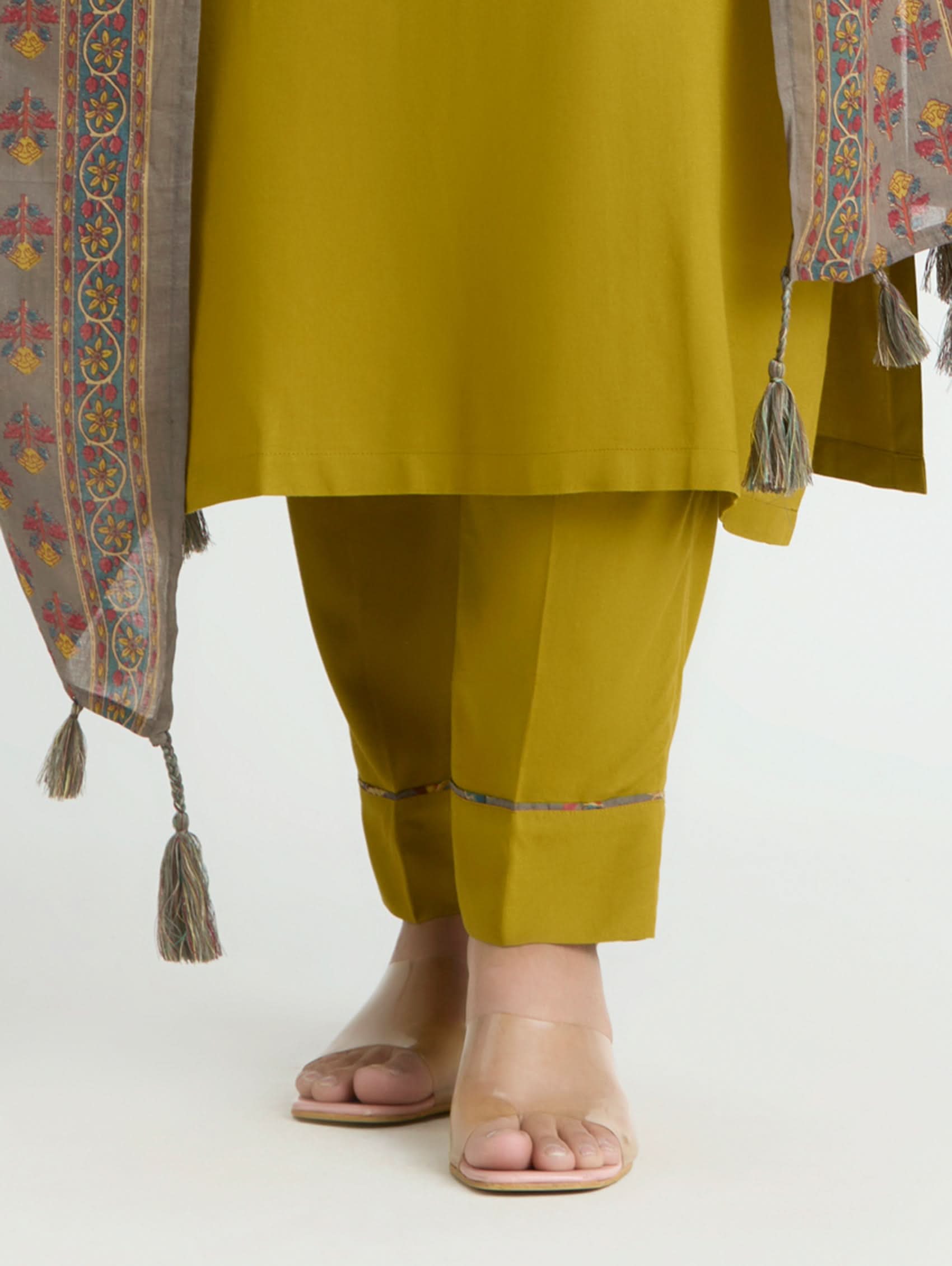 Mustard yellow traditional outfit with a patterned shawl on a white background