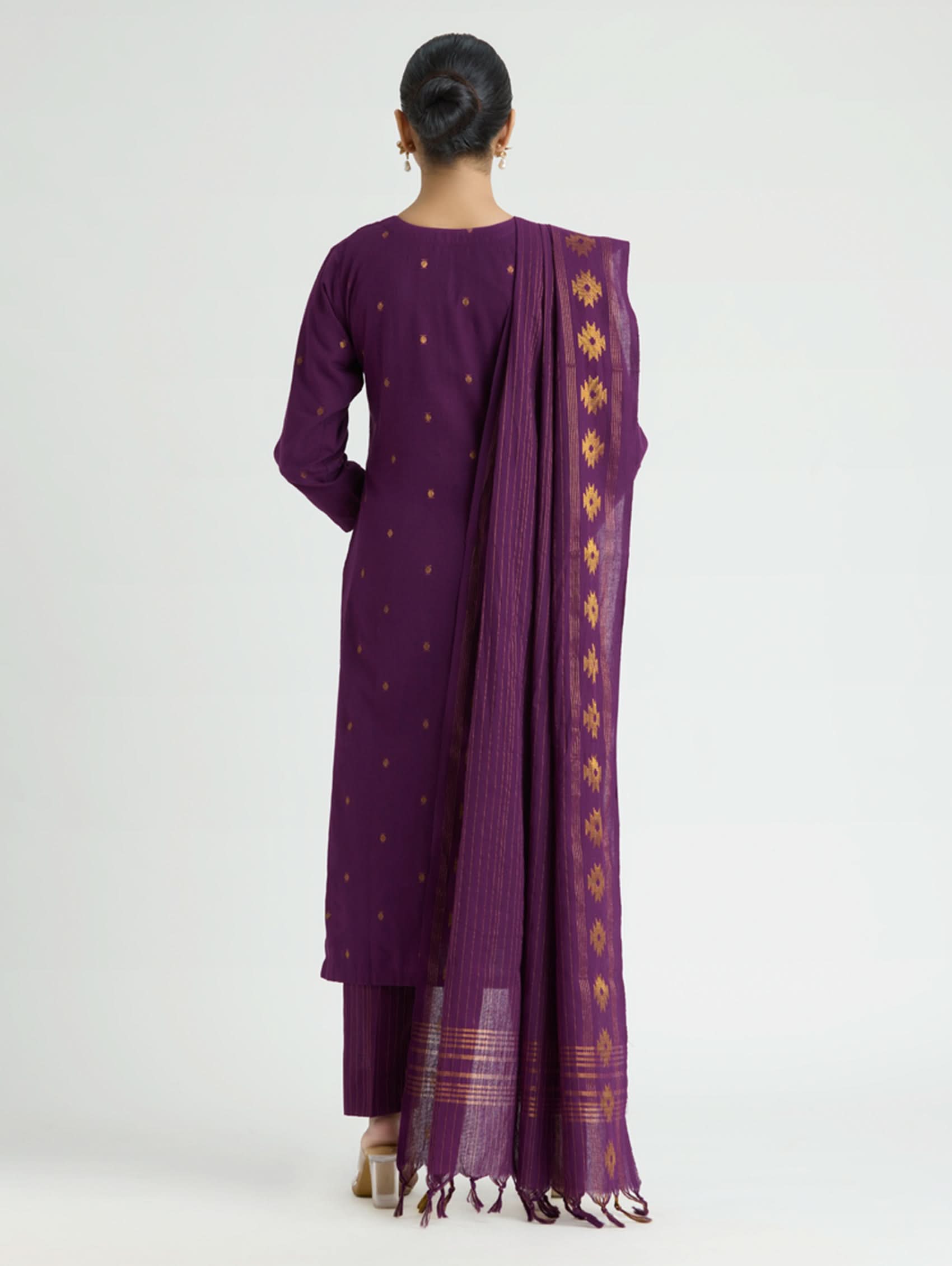 Person wearing a purple traditional outfit with a matching dupatta on a white background