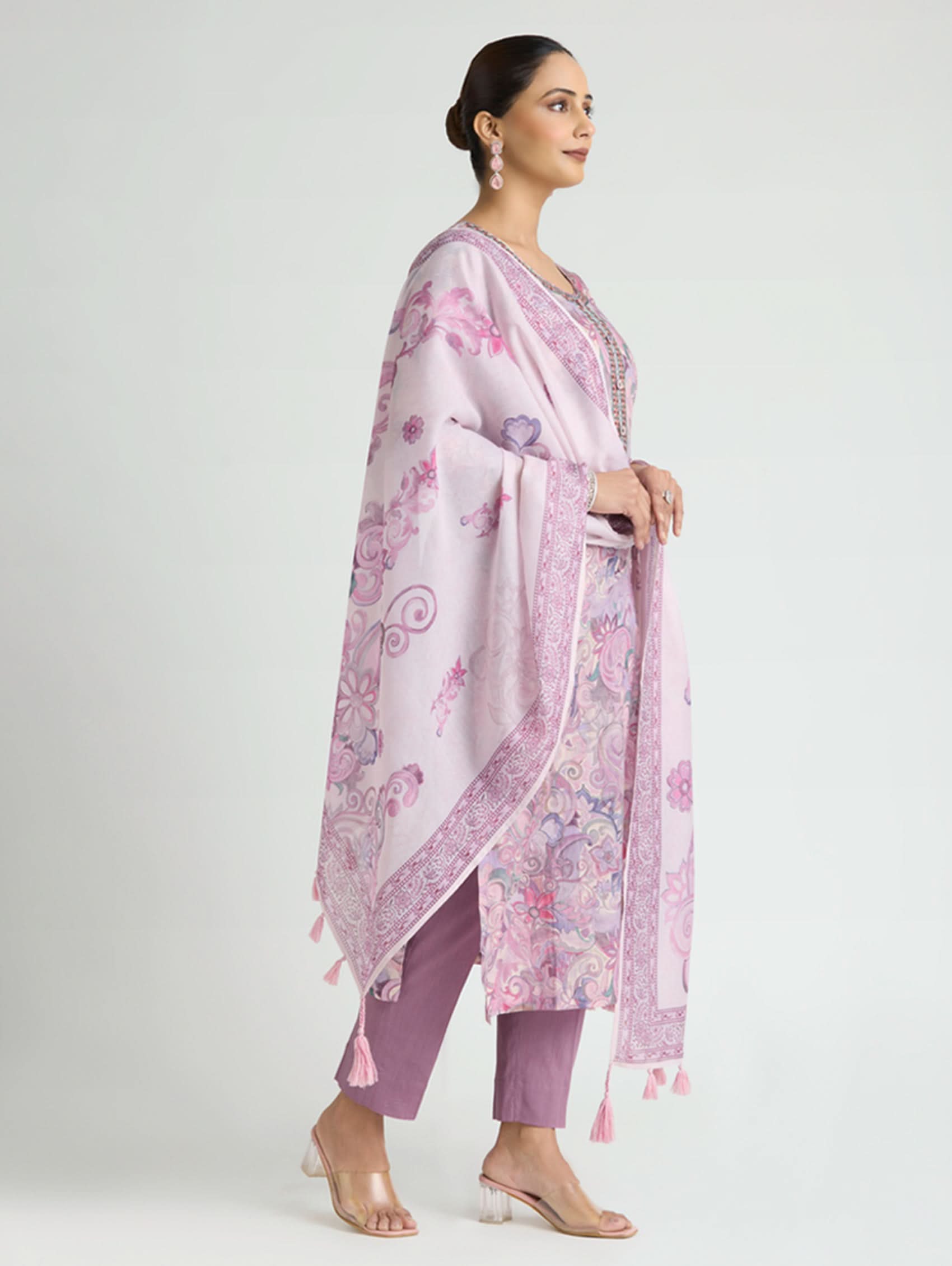 Woman wearing a pink floral dupatta and pants on a white background