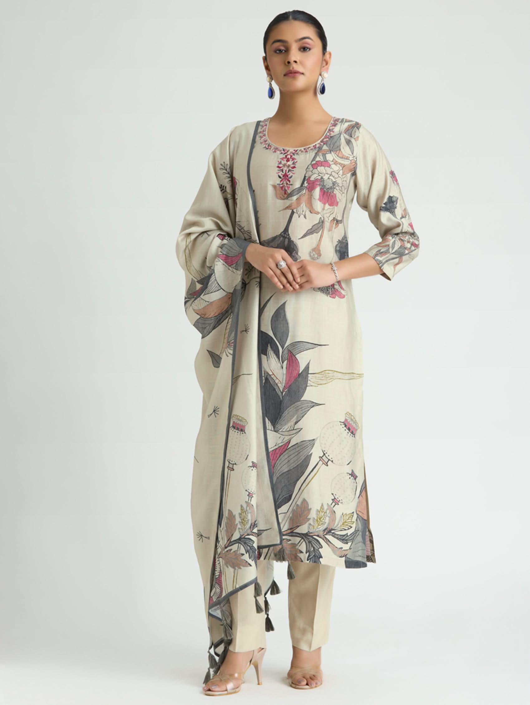 Woman wearing a floral kurta with a matching dupatta on a white background