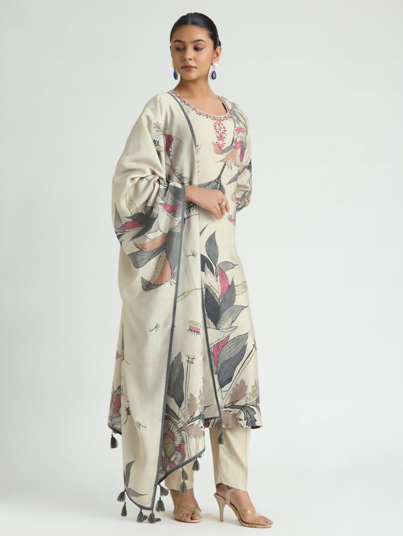 Woman wearing a floral dress with a plain background