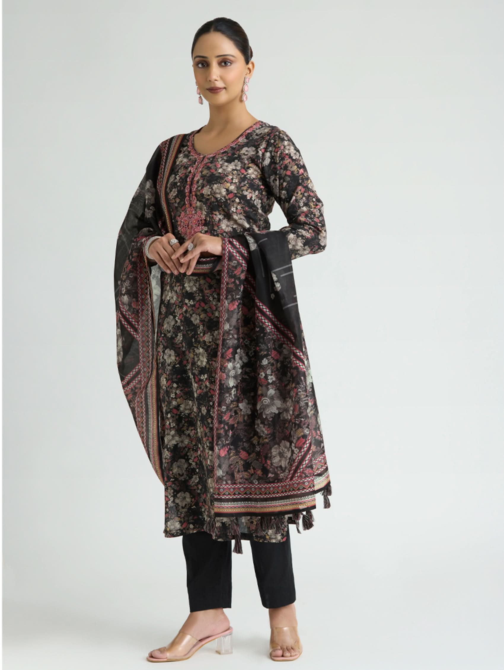 Woman wearing a floral kurta with black pants on a white background