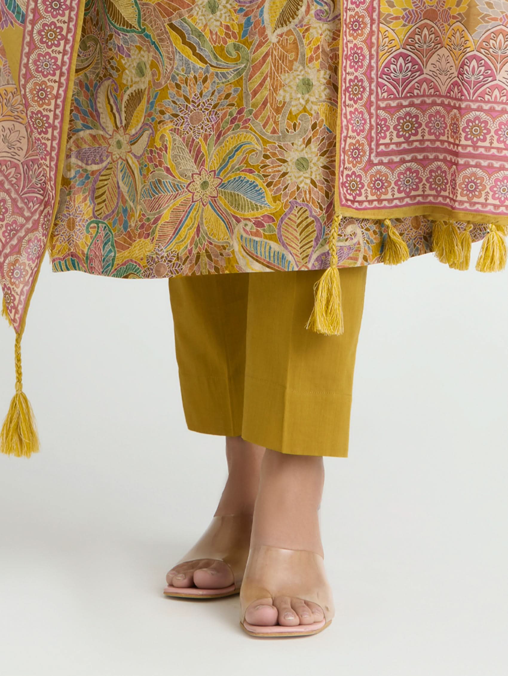 Traditional outfit with a colorful patterned dupatta and mustard yellow pants on a white background