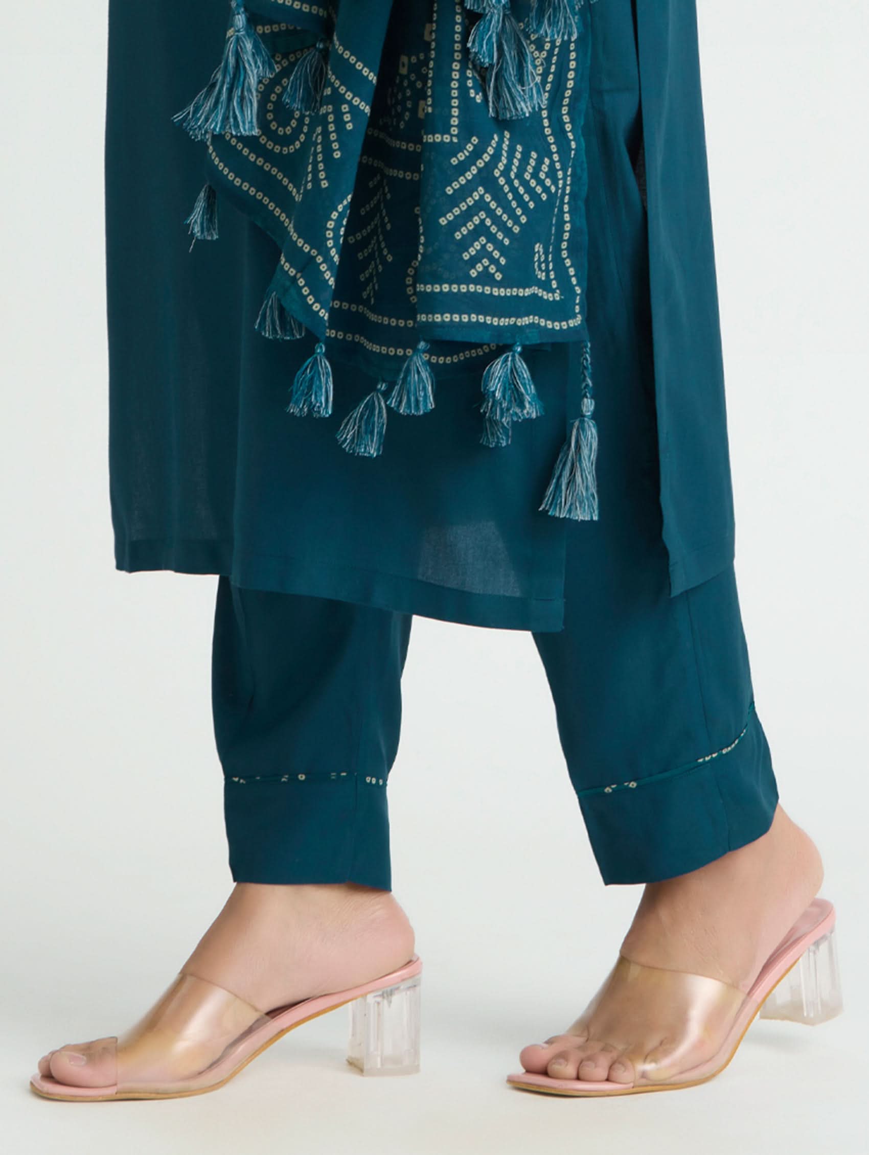 Teal traditional outfit with tassels and matching pants on a white background