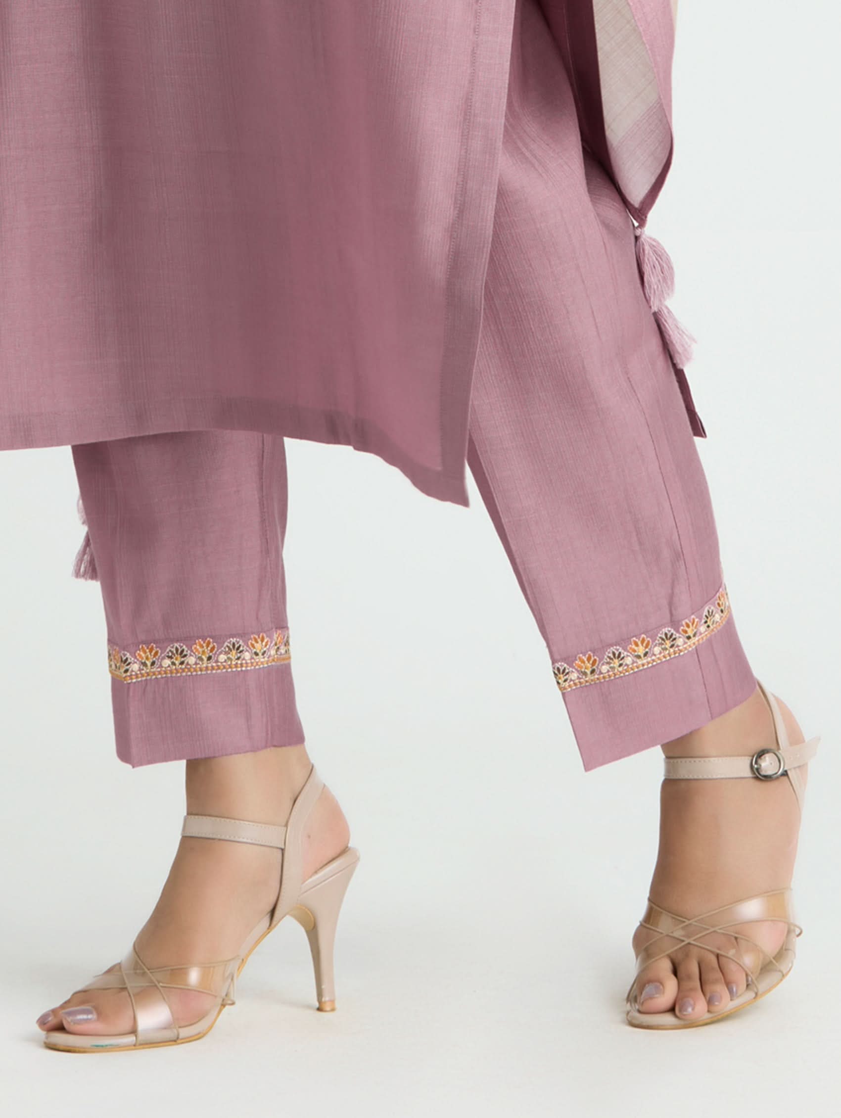 Mauve traditional outfit with embroidered pants on a white background